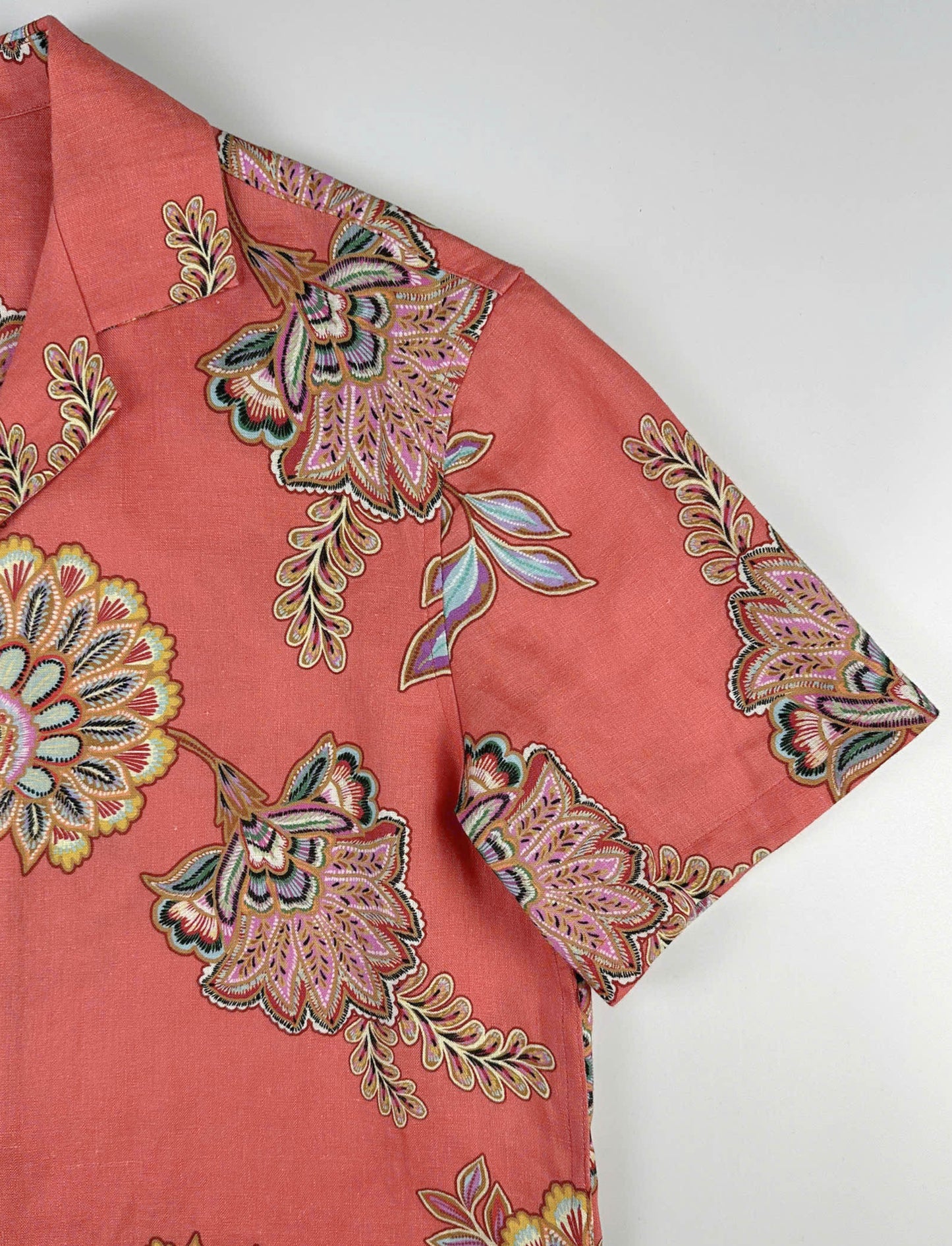 batik-inspired floral pattern on coral coloured fabric
