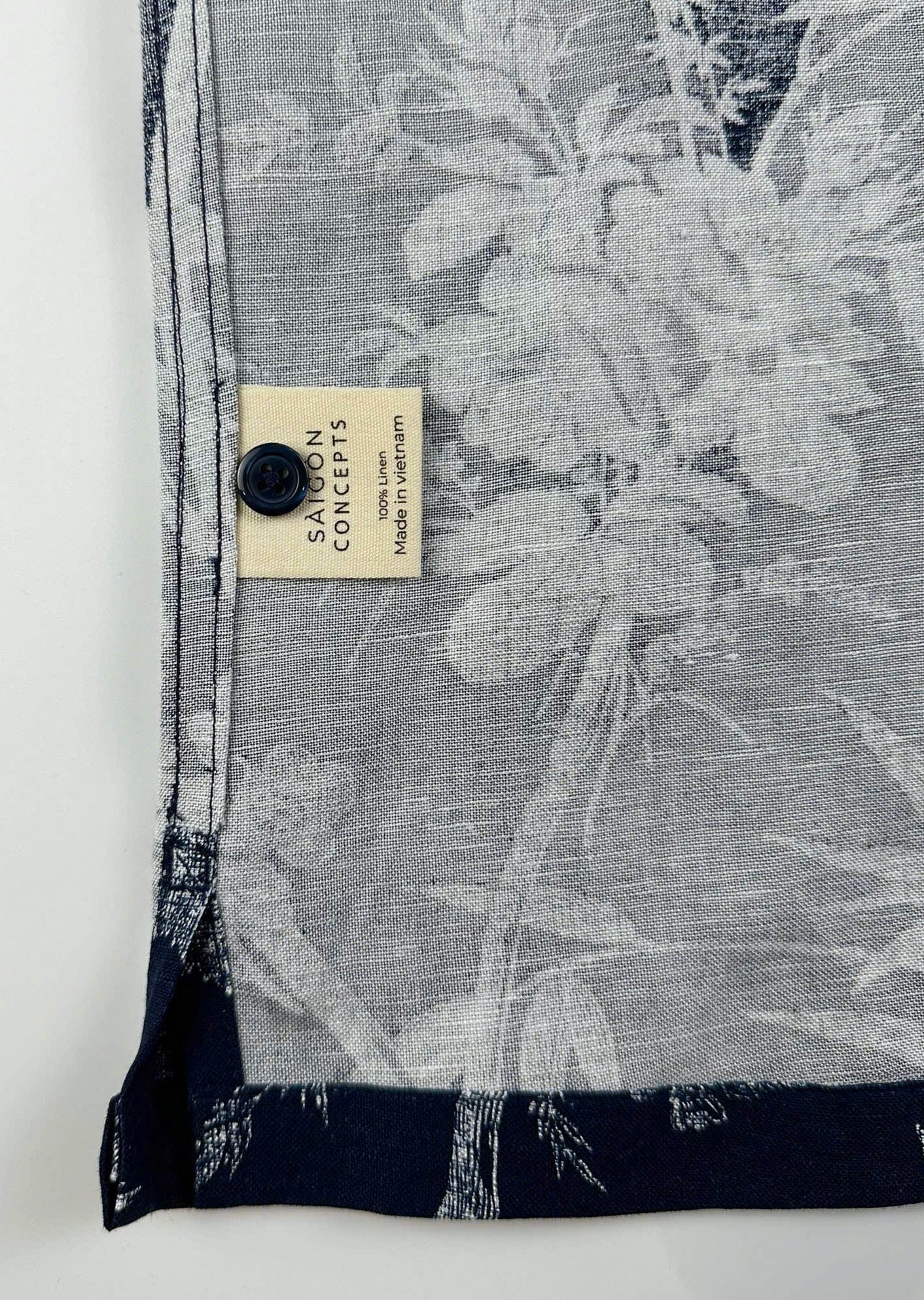 inside care label and seam detail - Navy linen Hawaiian shirt with white bamboo and blossom print