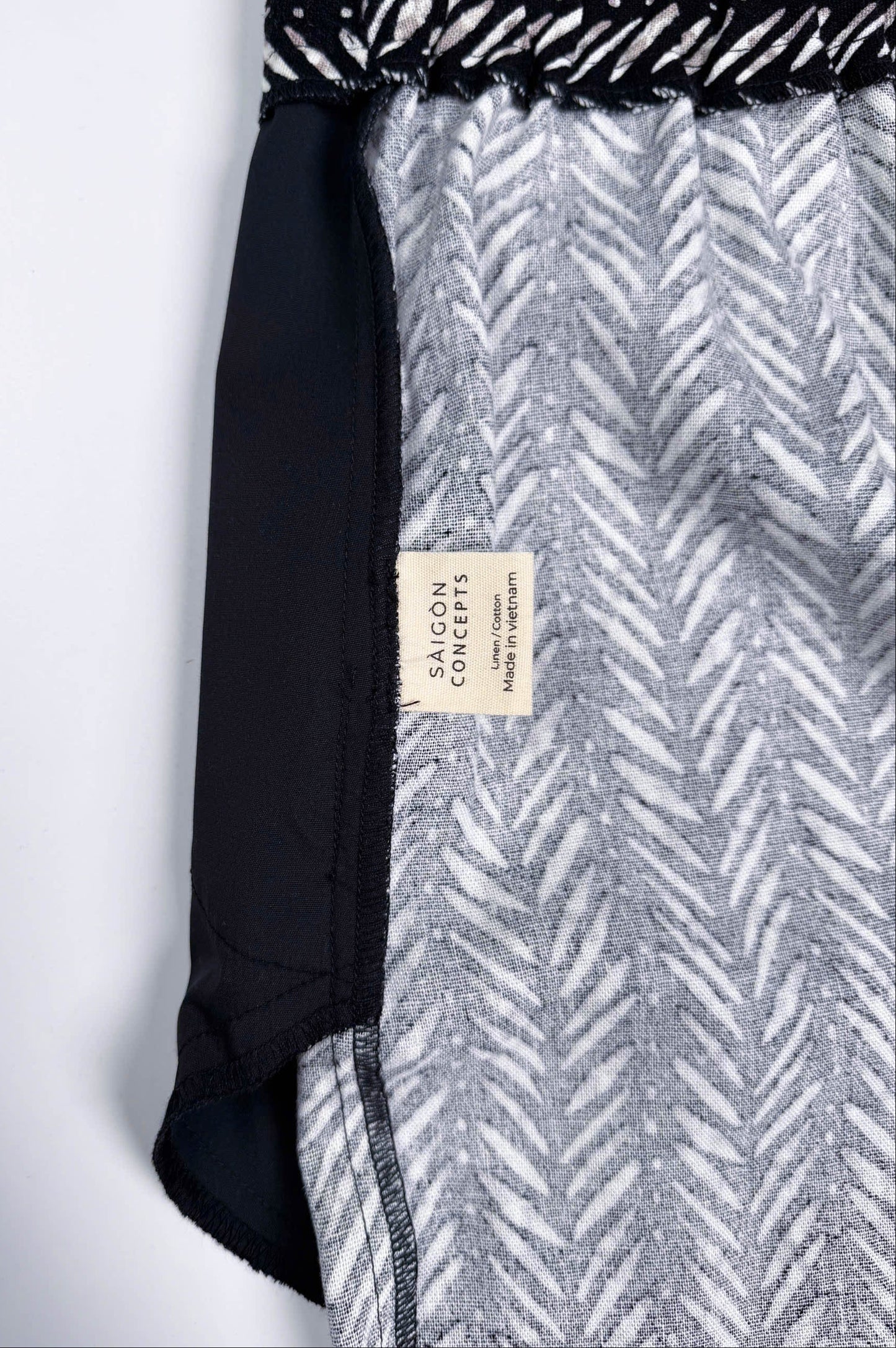Saigon Concepts Chevron Safari Linen Pants with white chevron painted lines print on black - inside care label view