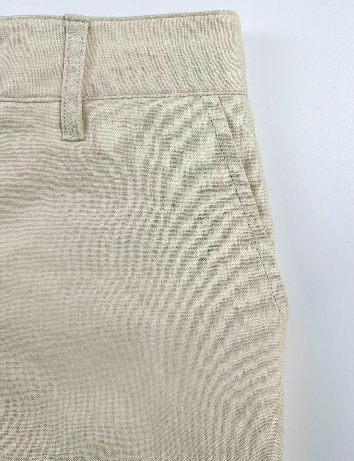 Sand coloured shorts pocket detail on a white background