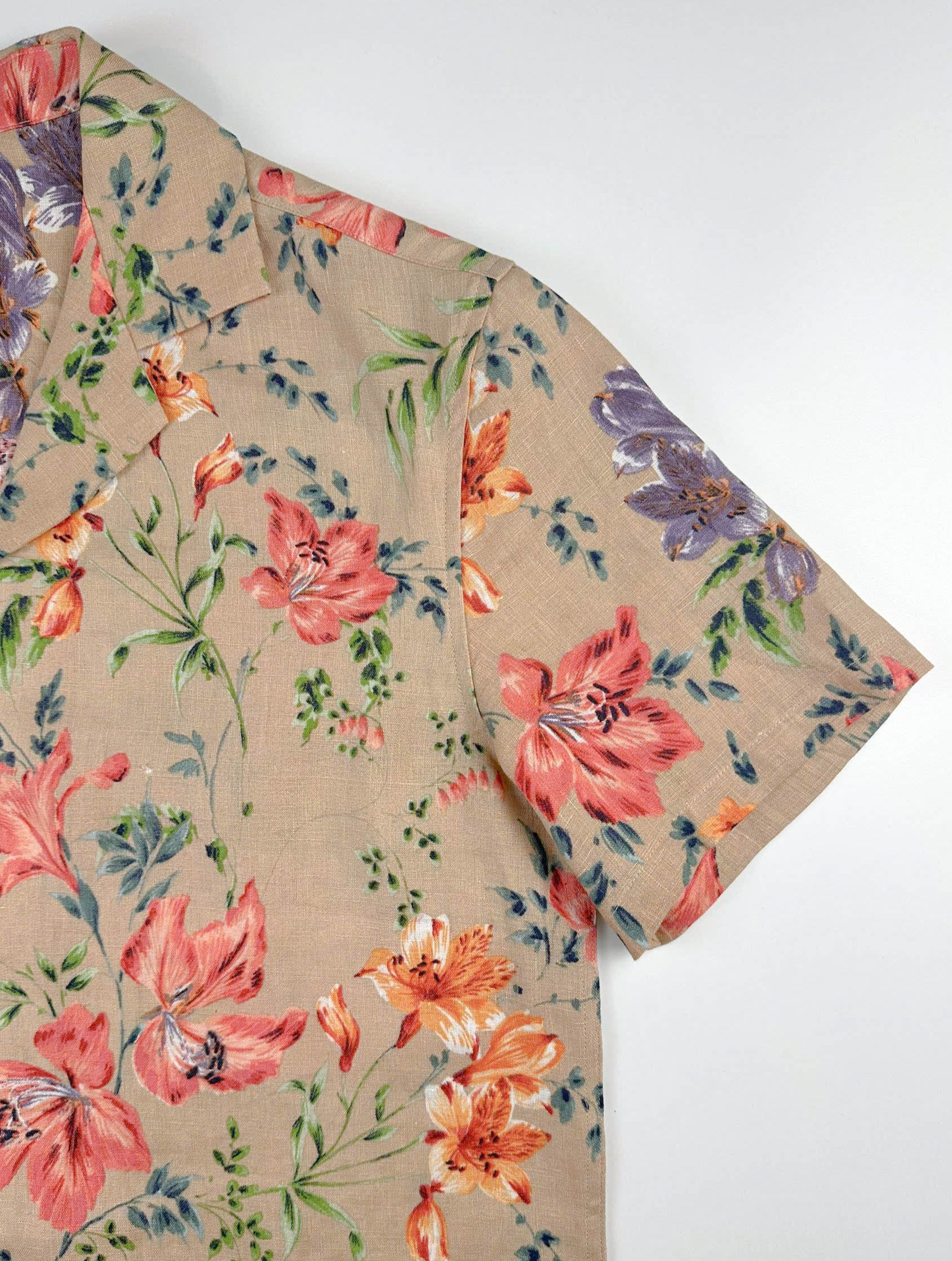 Sleeve detail - Vibrant Floral patterned linen Hawaiian style shirt on a sandy beige background