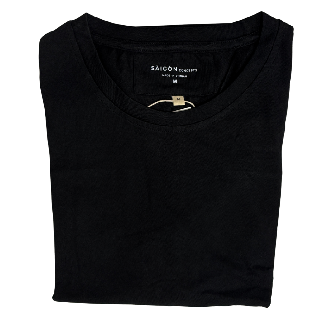 Folded black t-shirt with 'Saigon Concepts' label on a white background