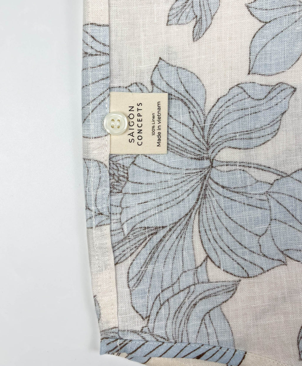 Blue Hibiscus linen long sleeve button-up shirt lay flat care label view