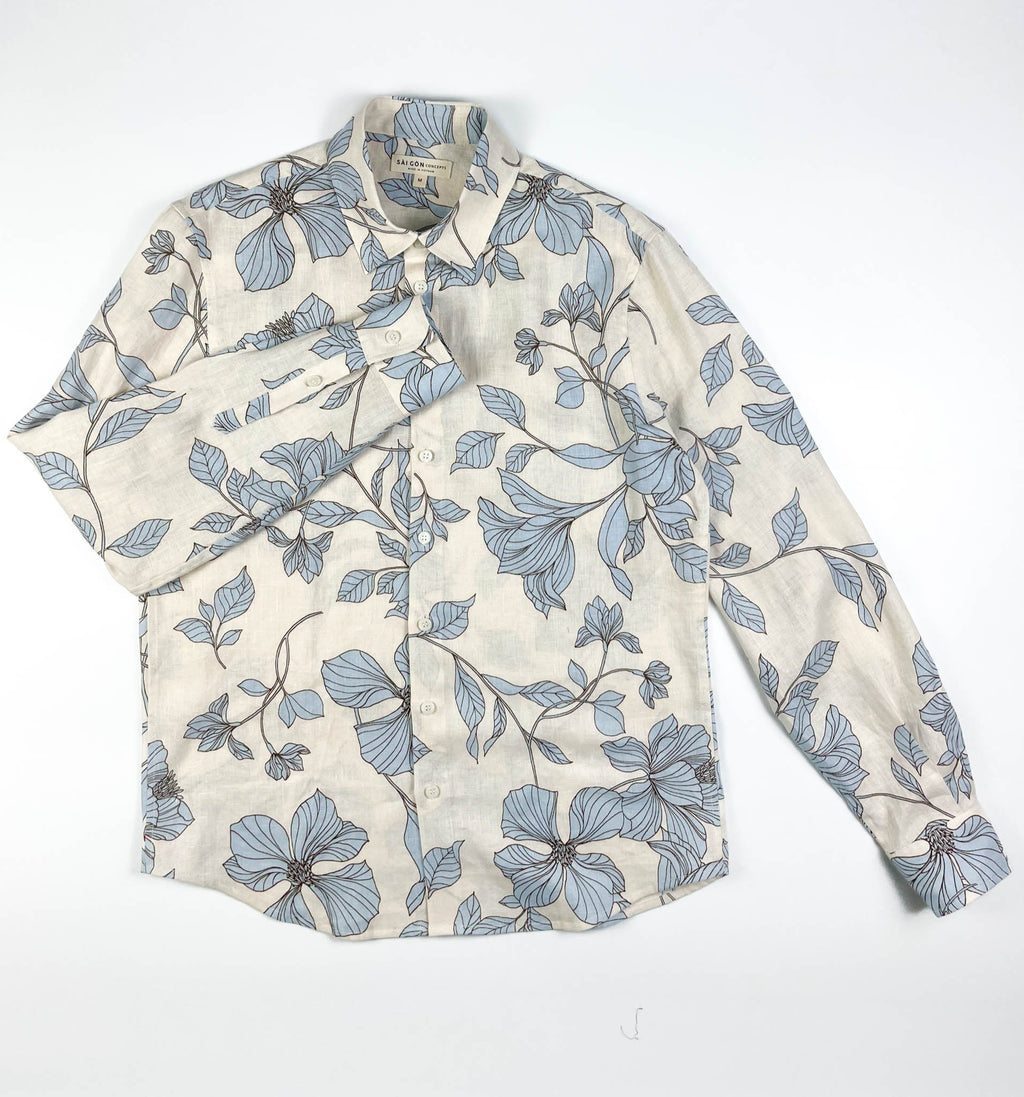 Blue Hibiscus linen long sleeve button-up shirt lay flat full front view, light blue hibiscus print on natural white linen