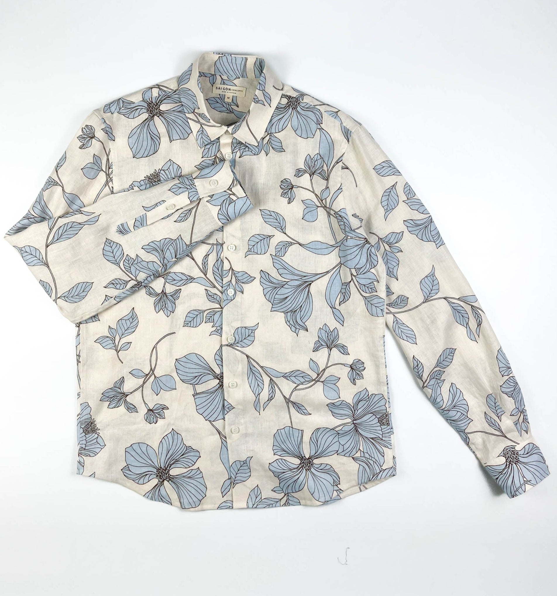 Blue Hibiscus linen long sleeve button-up shirt lay flat full front view, light blue hibiscus print on natural white linen