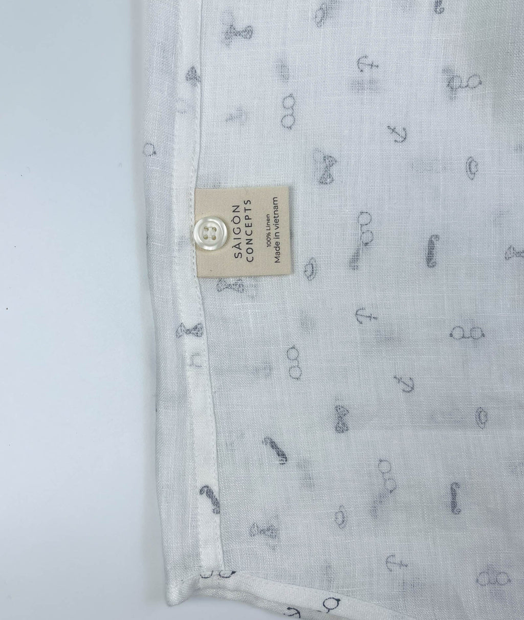 Gentlemen Club linen button-up shirt lay flat inside care label, minimalist print