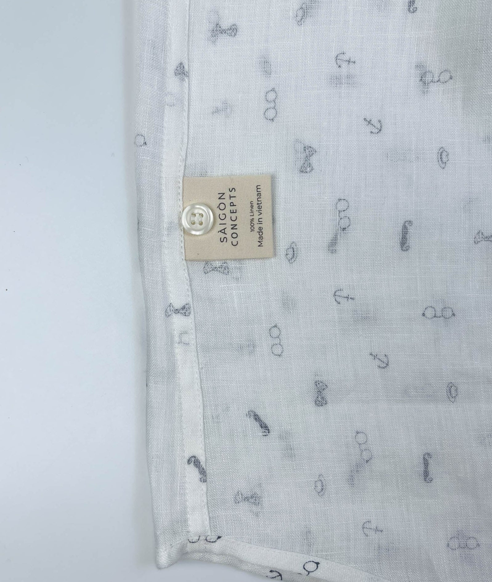 Gentlemen Club linen button-up shirt lay flat inside care label, minimalist print