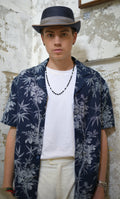 Model wearing Navy & White Hawaiian Shirt open with White Tee and White Linen Pants