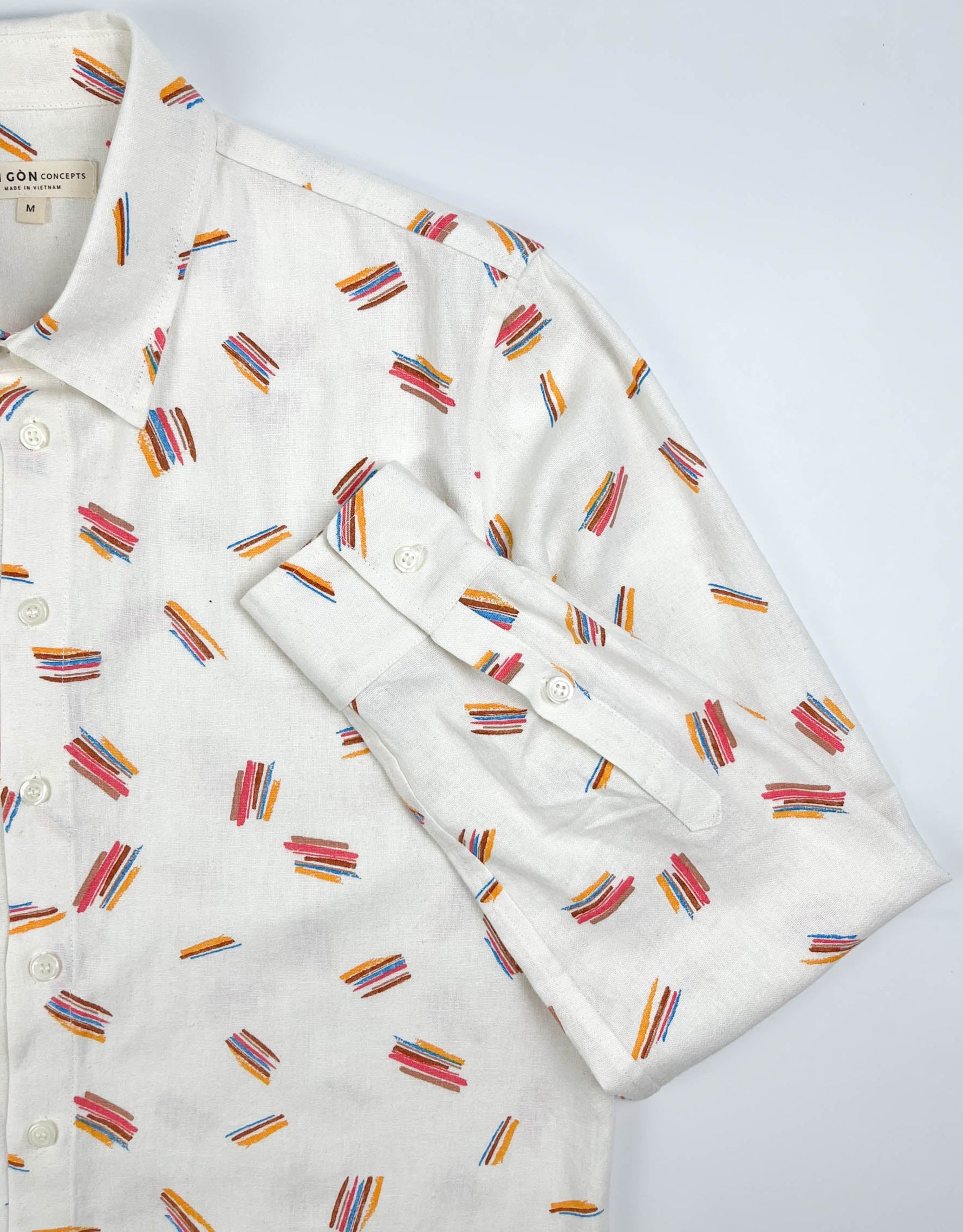Crayon Strokes linen long sleeve button-up shirt with colourful crayon stroke print on natural white fabric - lay flat sleeve detail view