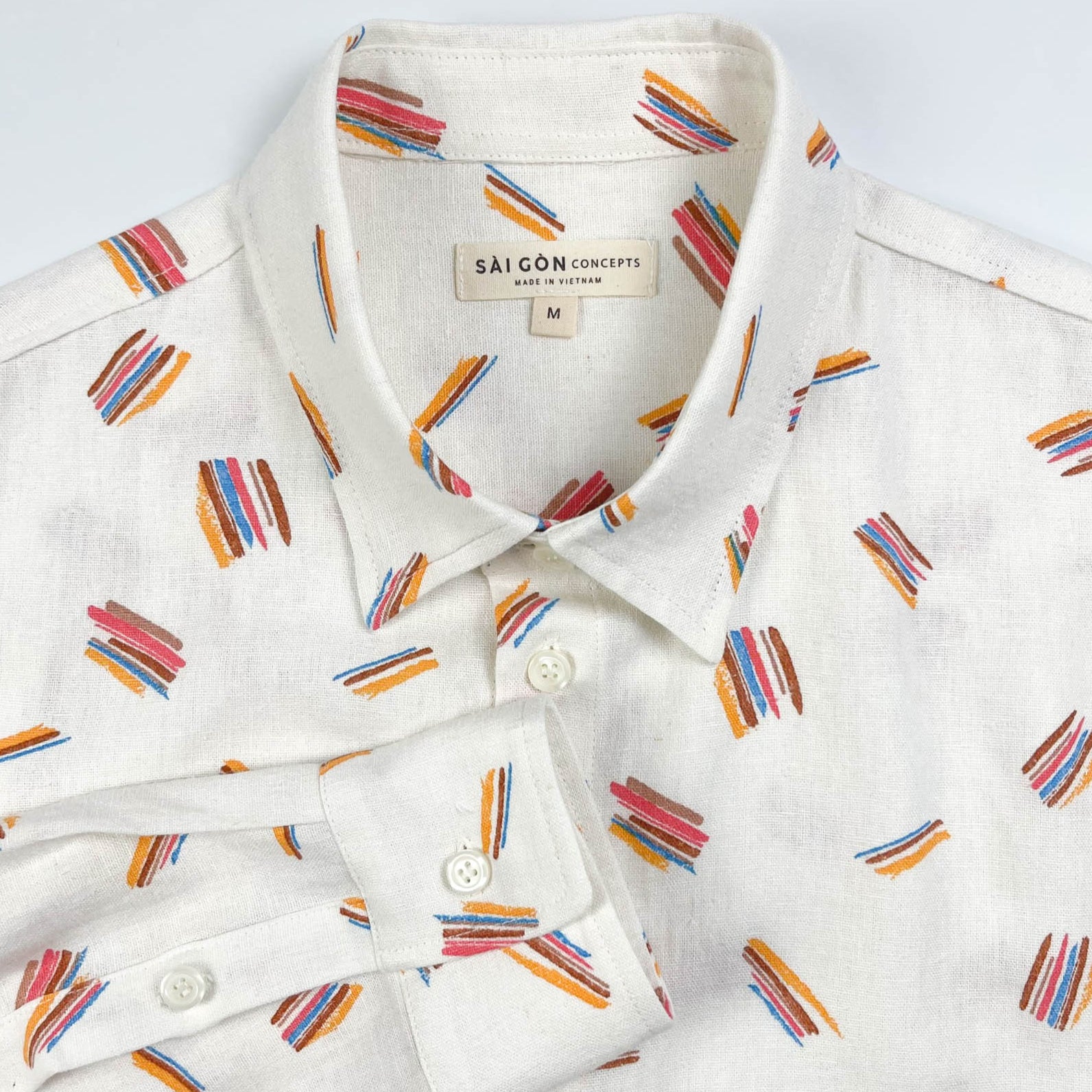Crayon Strokes linen long sleeve button-up shirt with colourful crayon stroke print on natural white fabric - lay flat front neck detail view