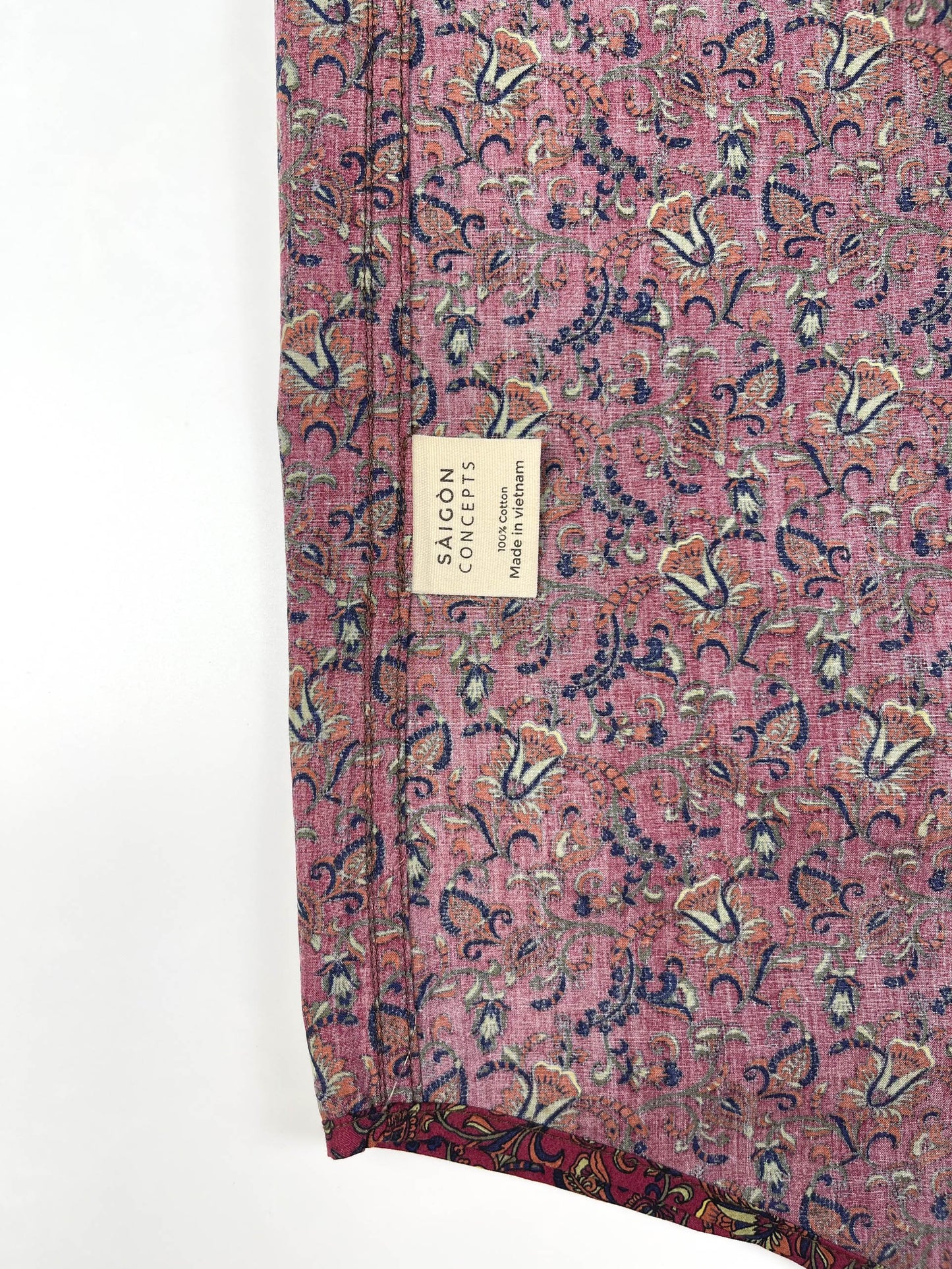 Crimson Vines cotton short sleeve button-up shirt lay flat inside care label view, crimson with detailed vine floral print