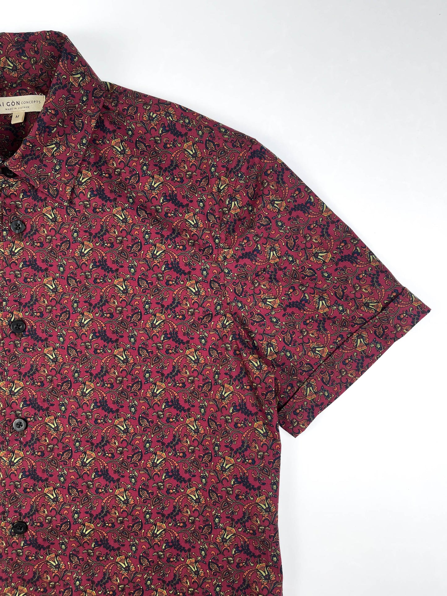 Crimson Vines cotton short sleeve button-up shirt lay flat sleeve detail view, crimson with detailed vine floral print