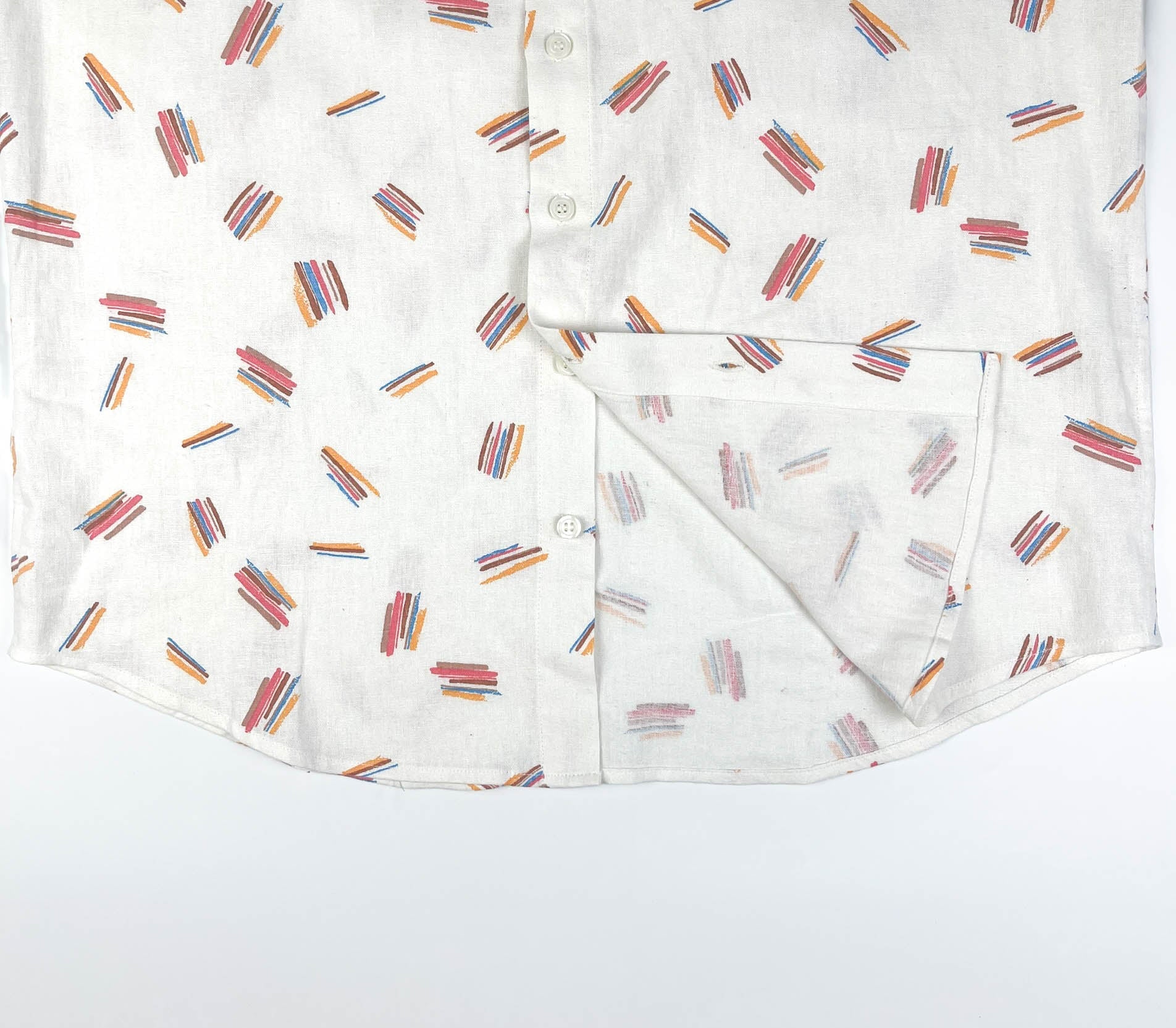 Crayon Strokes on natural white linen fabric, button-up shirt lay flat inside seam detail view
