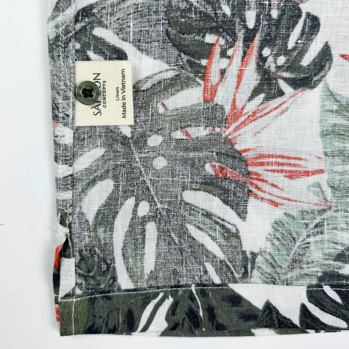 Saigon Concepts Fire & Fern Hawaiian Shirt - tropical jungle print with monstera ferns and bird of paradise florals on natural white linen - care label detail view