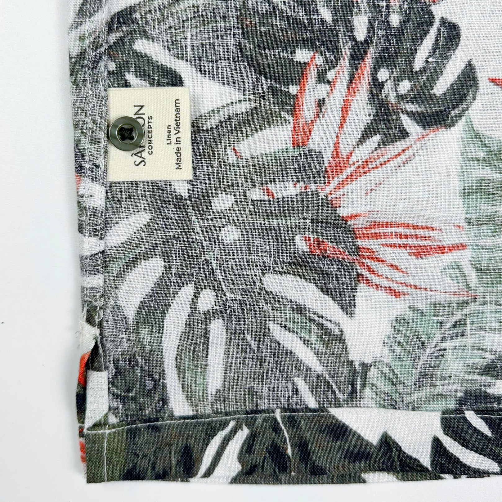 Saigon Concepts Fire & Fern Hawaiian Shirt - tropical jungle print with monstera ferns and bird of paradise florals on natural white linen - care label detail view