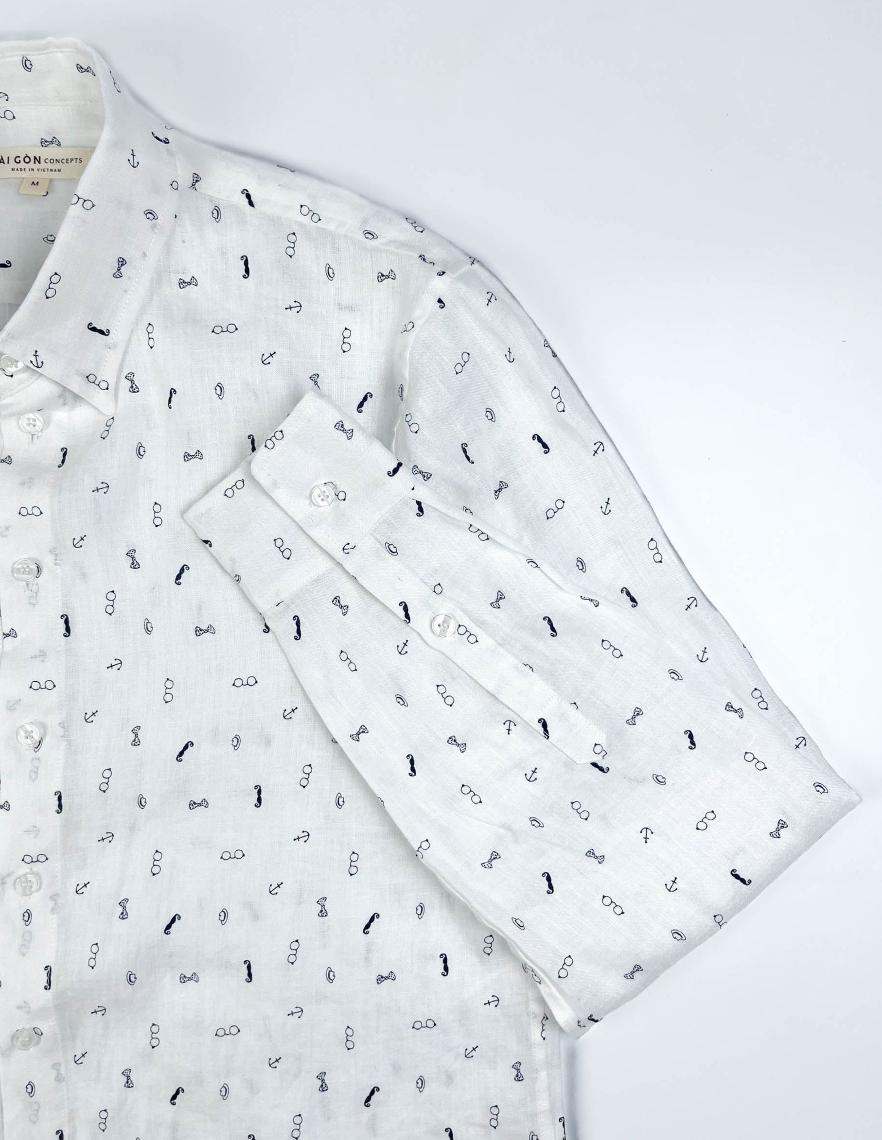 Gentlemen Club linen long sleeve button-up shirt lay flat sleeve detail view, minimalist print on white linen