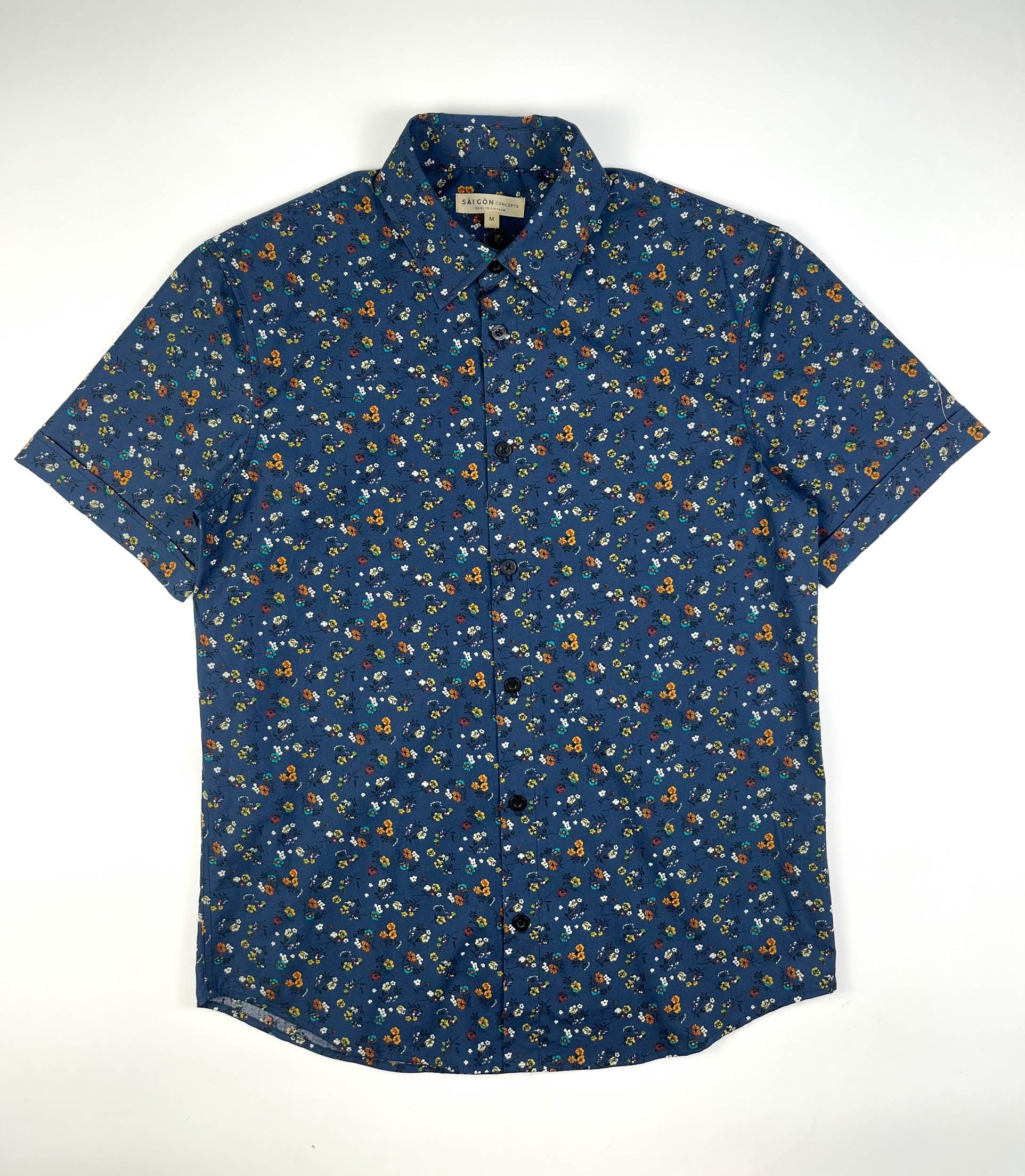 Indigo Meadow cotton short sleeve button-up shirt lay flat full front, meadow floral print on indigo base fabric