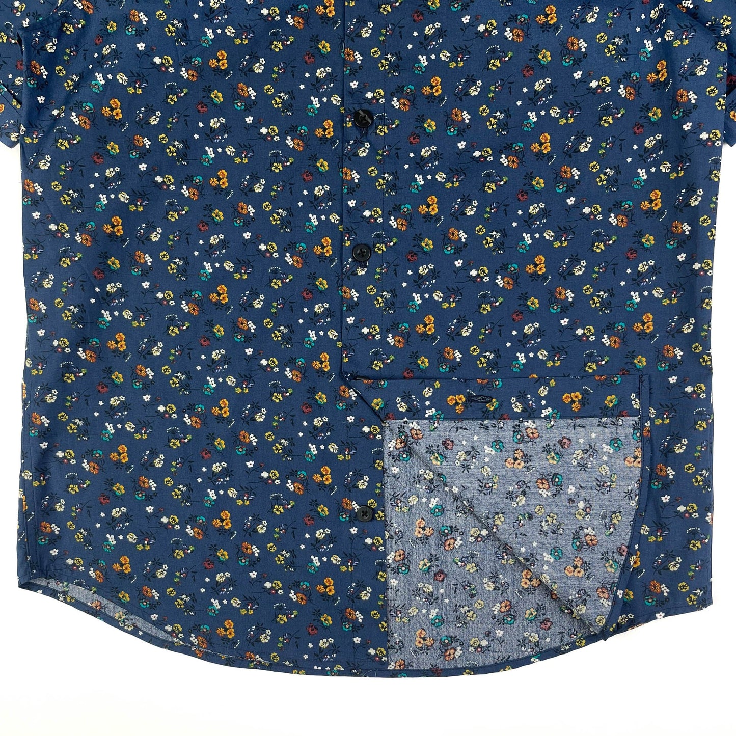 Indigo Meadow cotton short sleeve button-up shirt lay flat inside seam detail view, meadow floral print on indigo base fabric