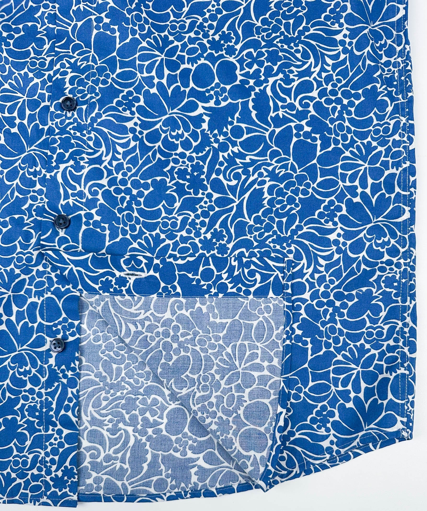 Monet Blue short sleeve button-up shirt lay flat inside seam detail view, blue floral print with white linework