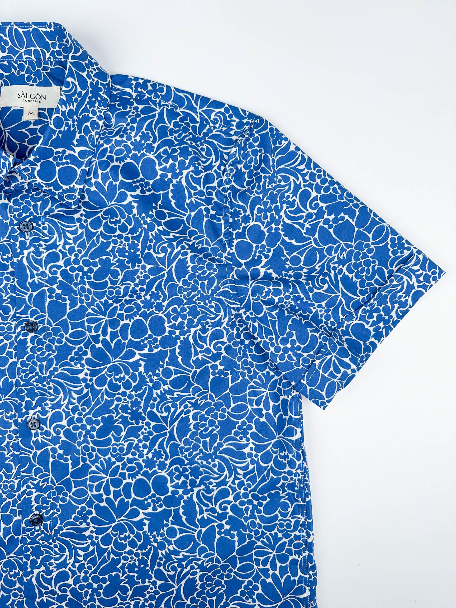 Monet Blue short sleeve button-up shirt lay flat sleeve detail view, blue floral print with white linework