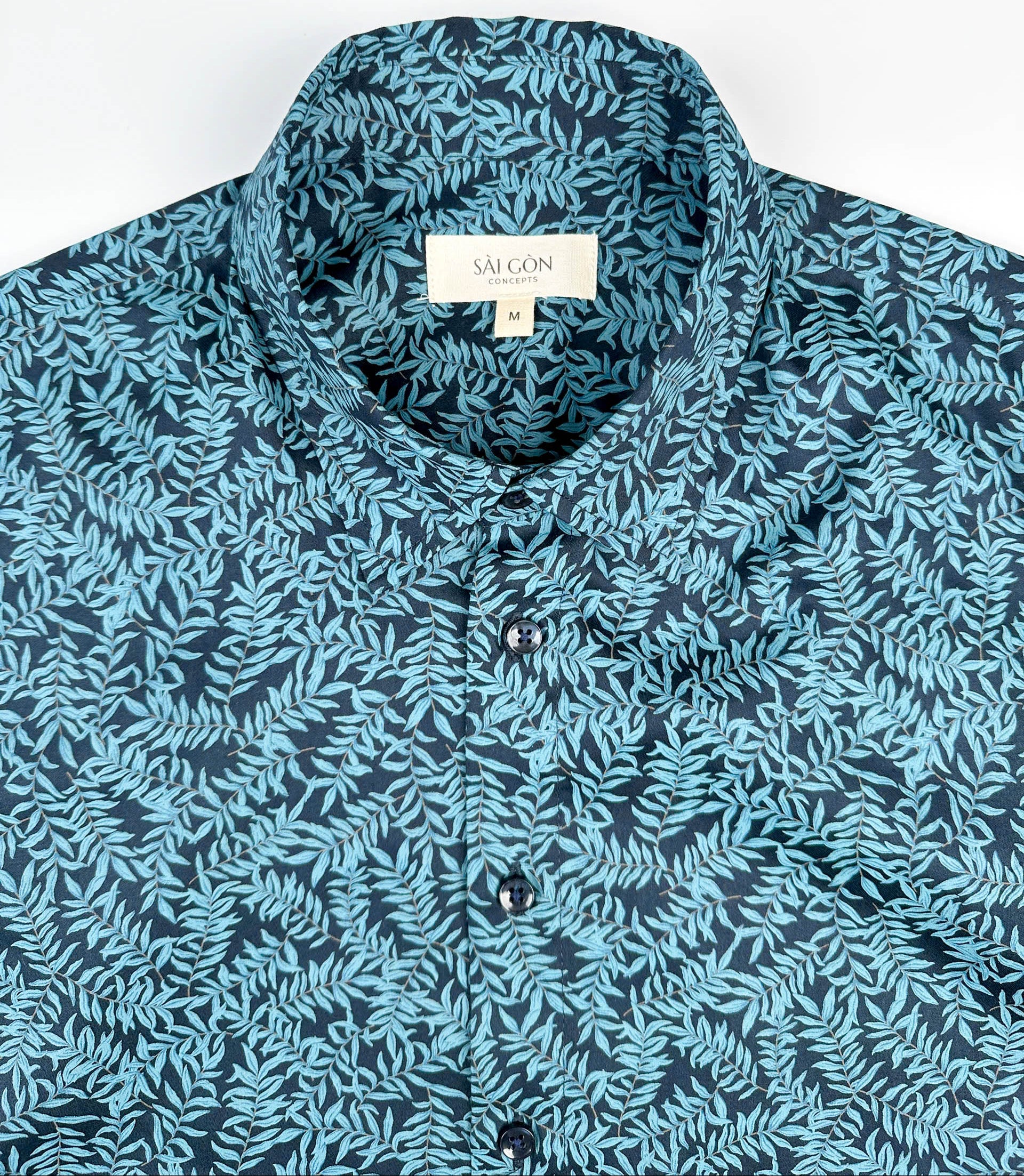 Mossy Leaf cotton short sleeve button-up shirt, teal blue leaf print on navy, front collar view