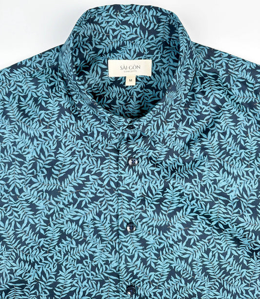 Mossy Leaf cotton short sleeve button-up shirt, teal blue leaf print on navy, front collar view