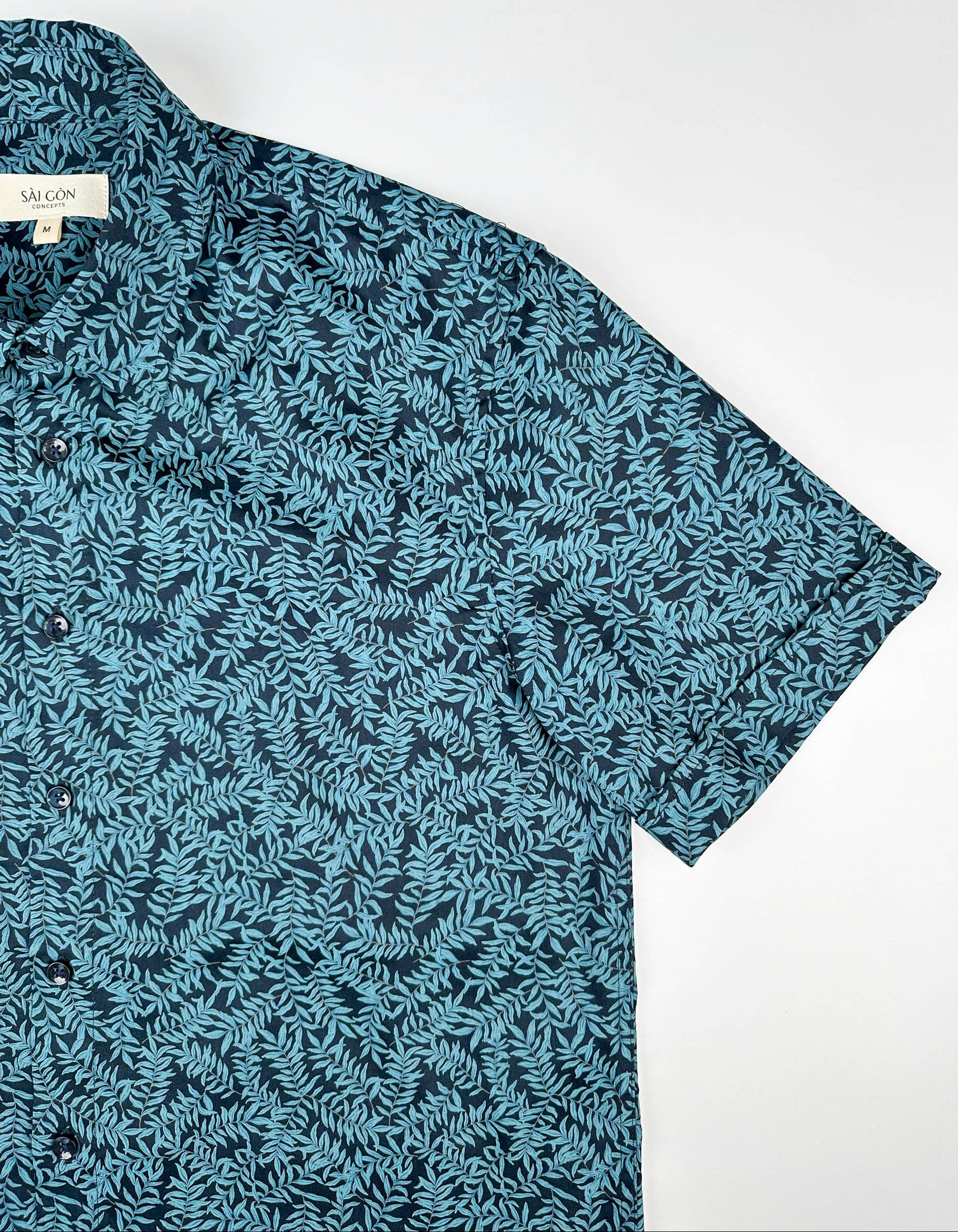 Mossy Leaf cotton short sleeve button-up shirt, teal blue leaf print on navy, sleeve lay flat view