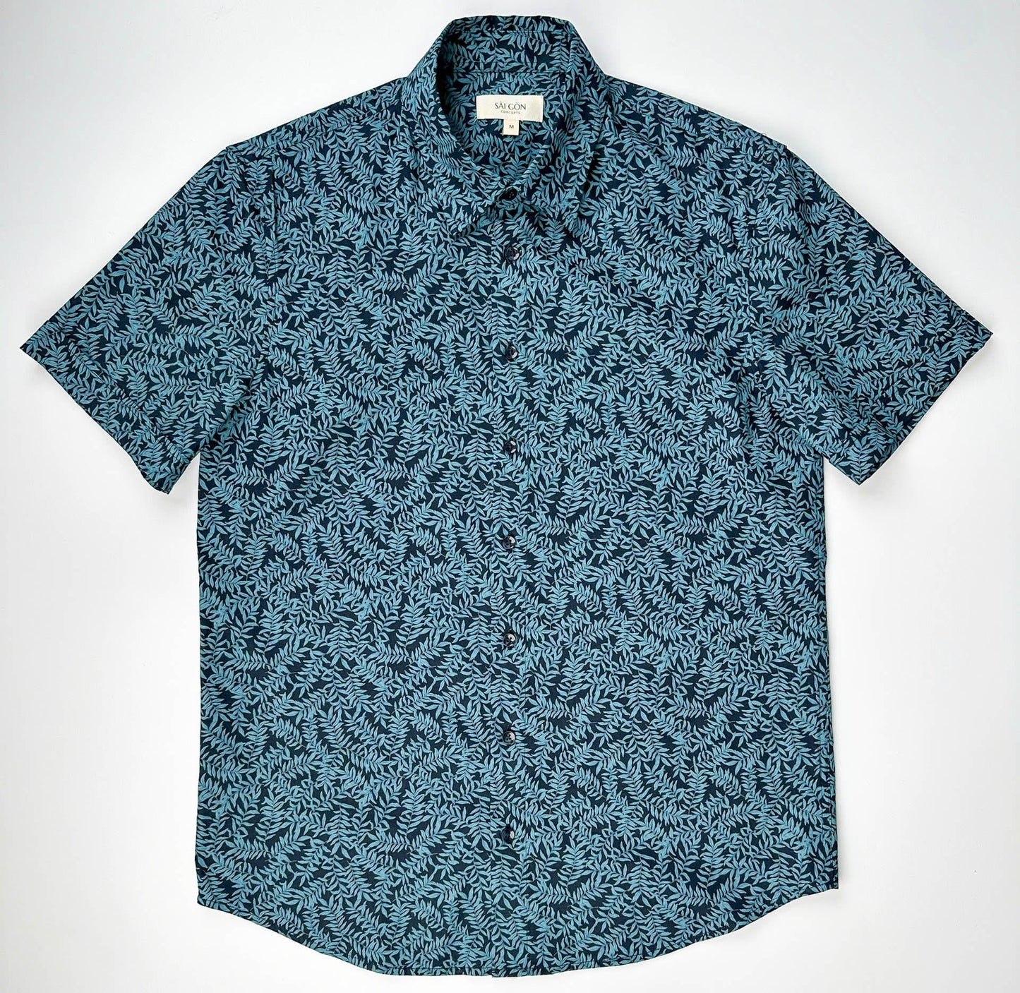 Mossy Leaf cotton short sleeve button-up shirt, teal blue leaf print on navy, front lay flat view