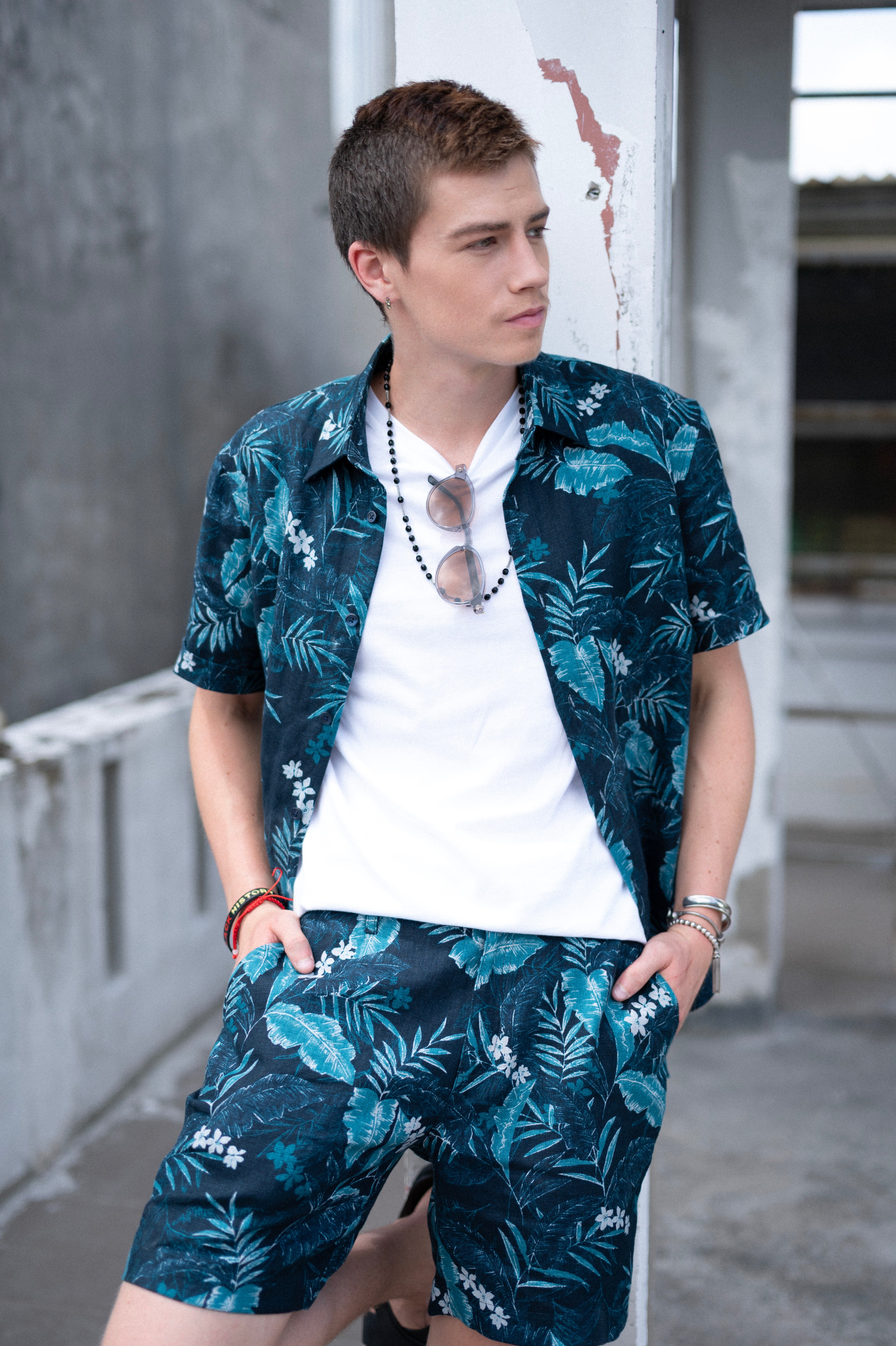 Man wearing a matching floral  hawaiian shirt and shorts set in an urban setting