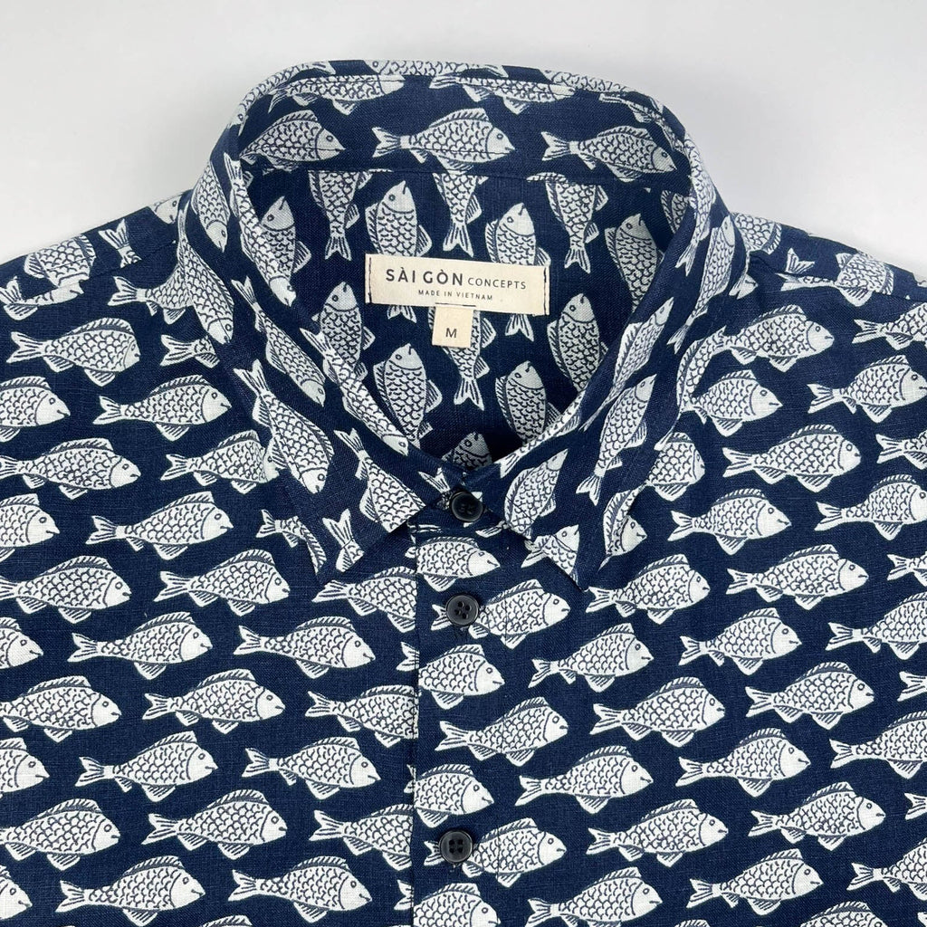 Darkwave Shoal linen short sleeve button-up shirt lay flat front, white fish shoal print on navy