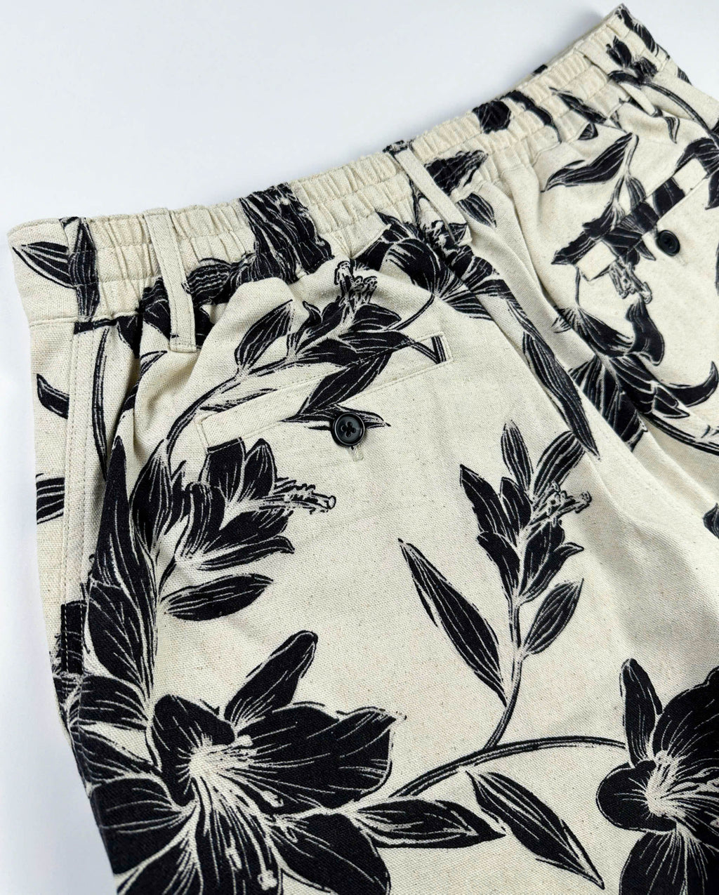 Beige linen-cotton shorts with black lily floral pattern 