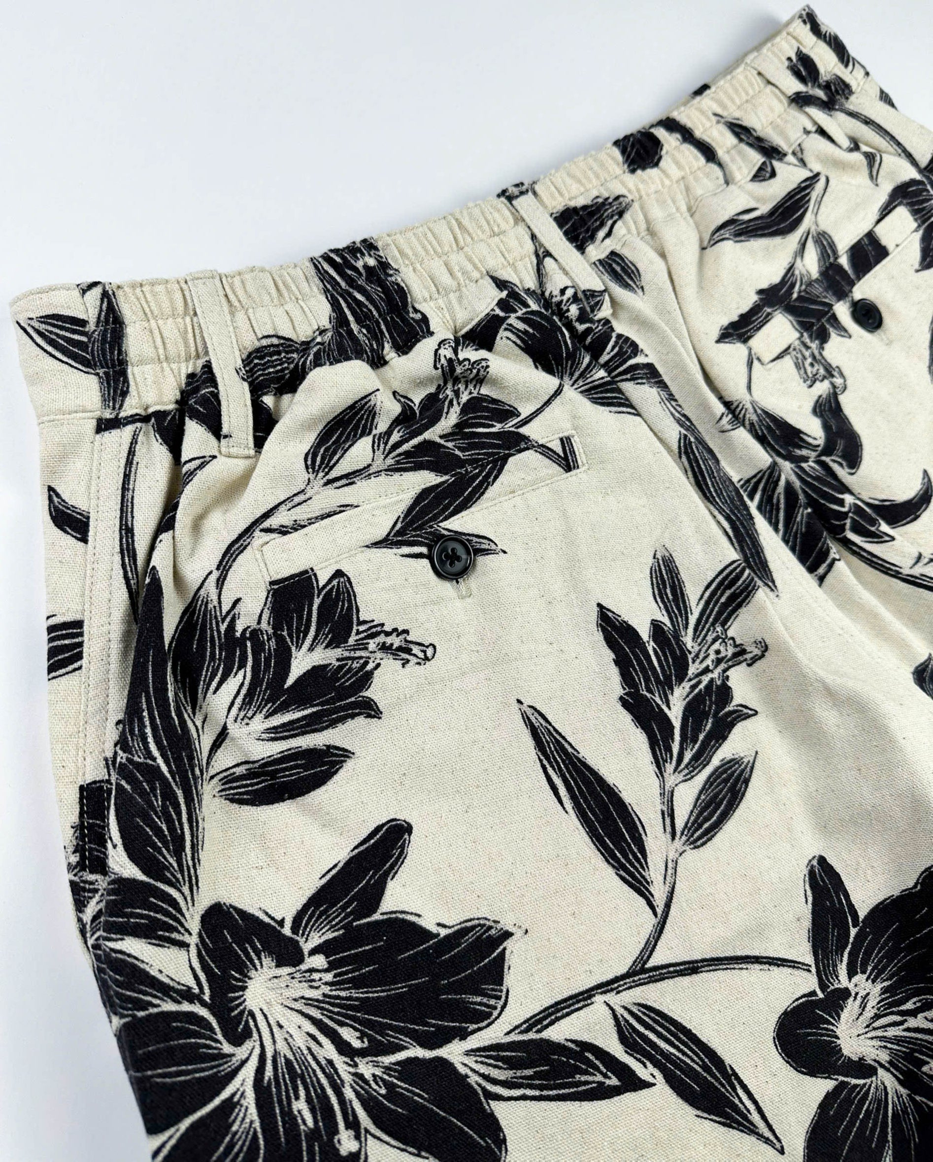 Beige linen-cotton shorts with black lily floral pattern 