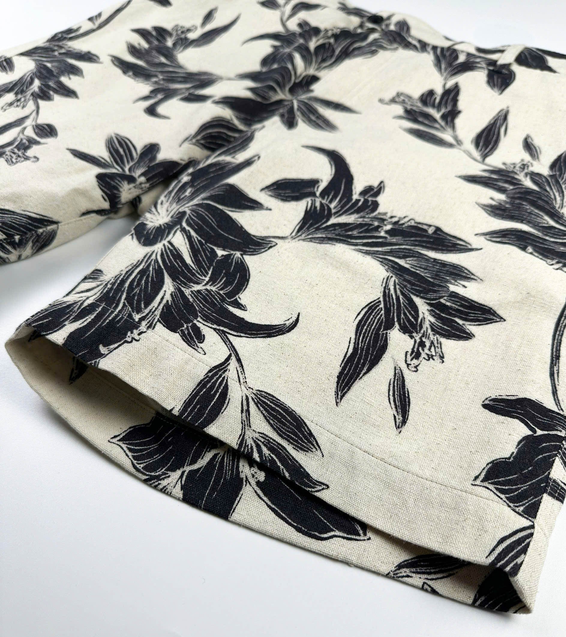 Beige linen-cotton shorts with black lily floral pattern 