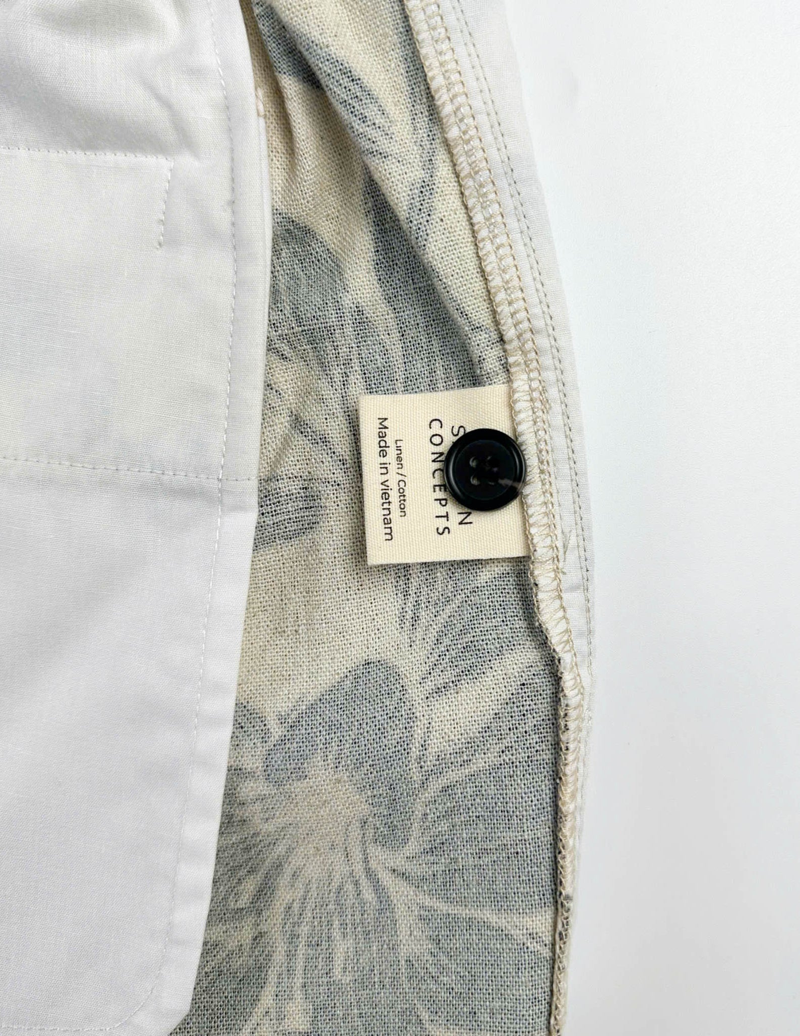 Beige linen-cotton shorts with black lily floral pattern 
