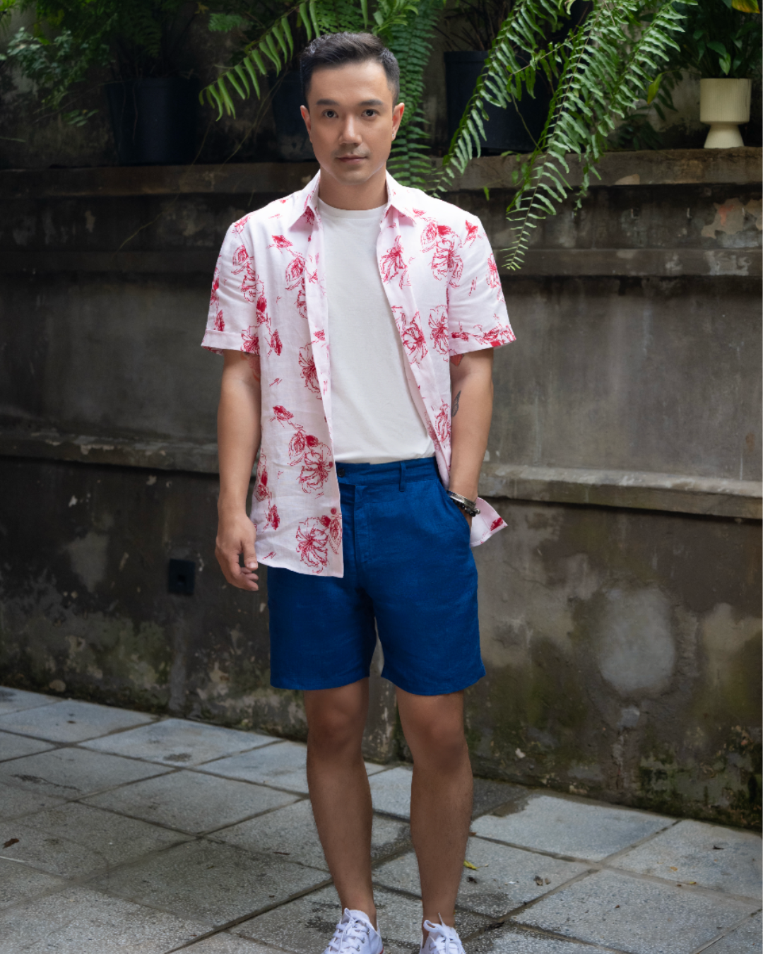 Ruby Aloha men’s white linen shirt with red sketch hibiscus print, with white cotton tee and dark blue linen shorts by Saigon Concepts