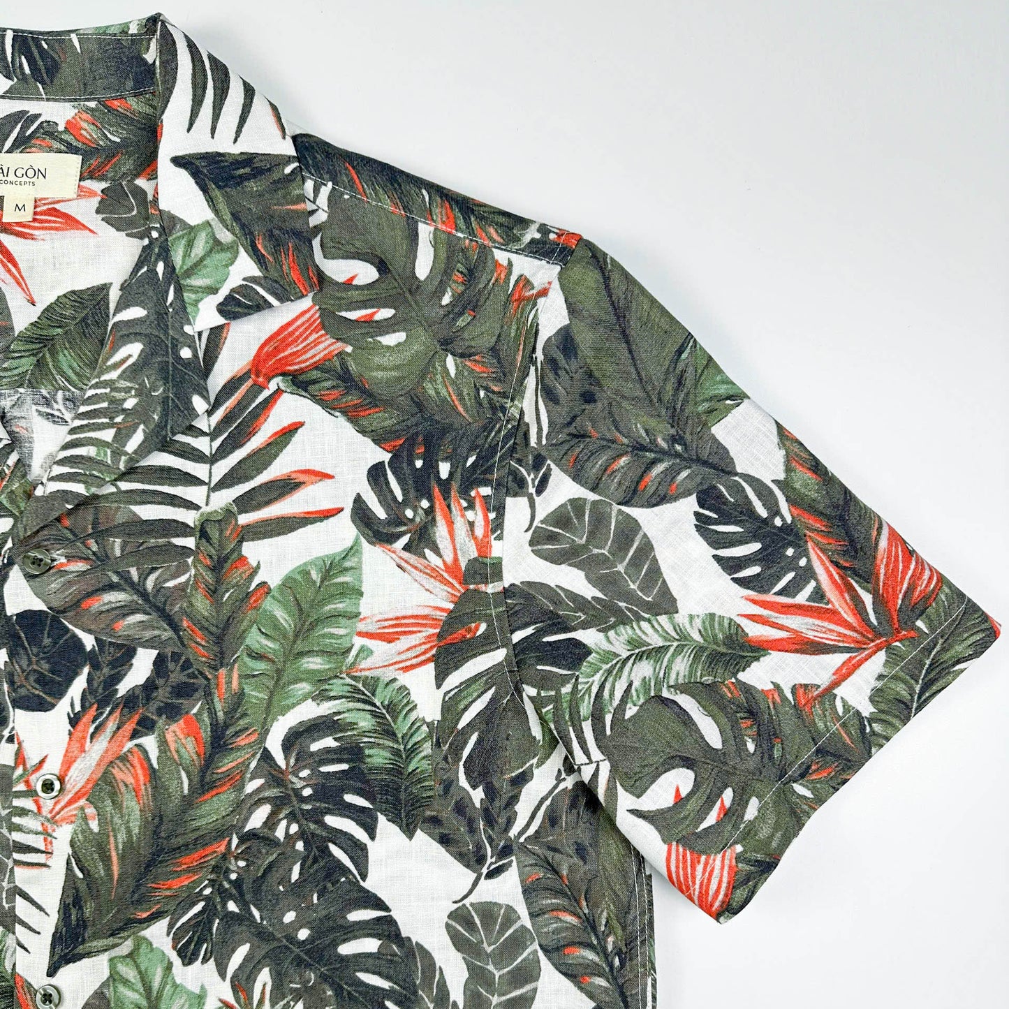 Saigon Concepts Fire & Fern Hawaiian Shirt - tropical jungle print with monstera ferns and bird of paradise florals on natural white linen - sleeve detail view