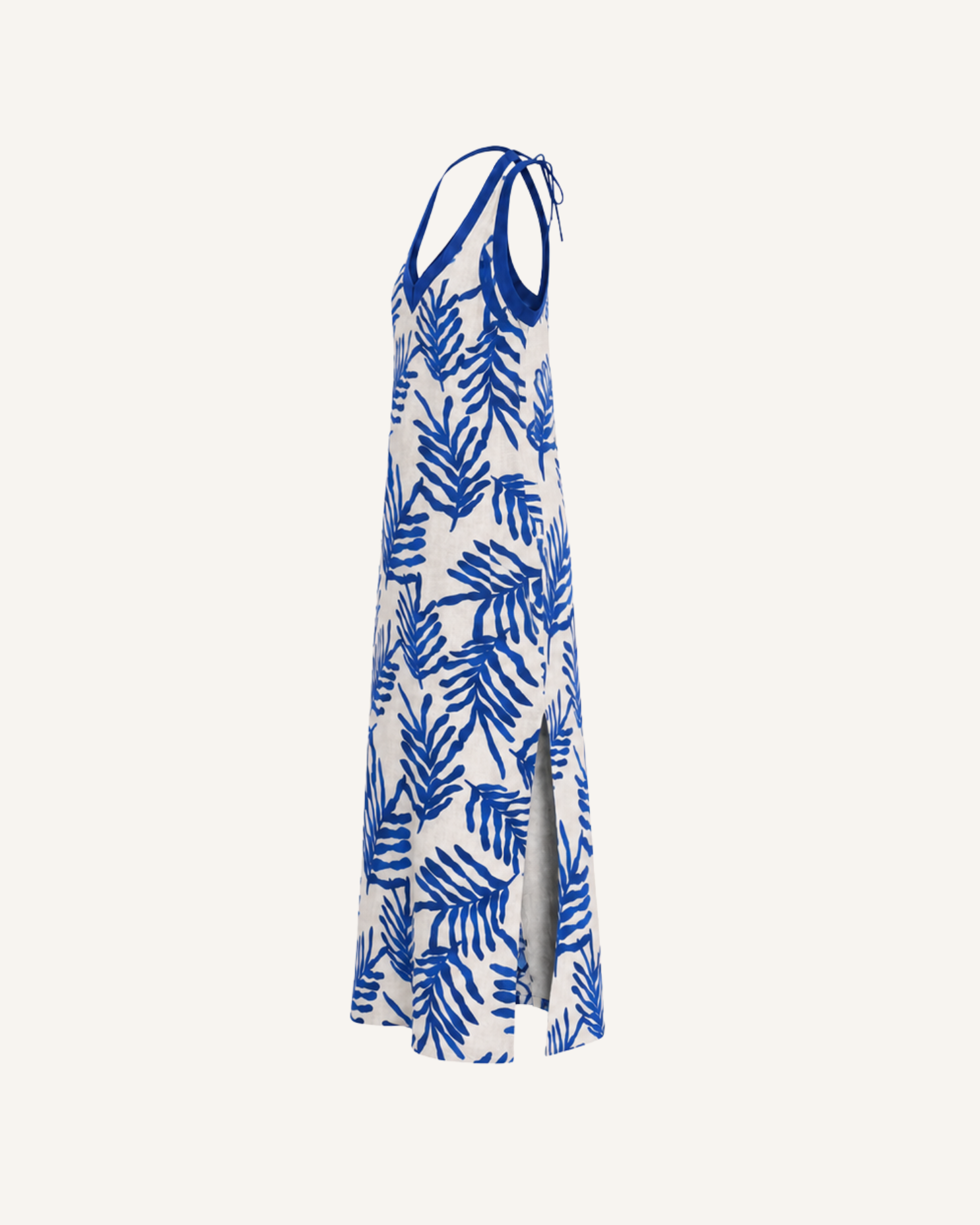 Close-up side view of a woman wearing a blue and white floral halter dress