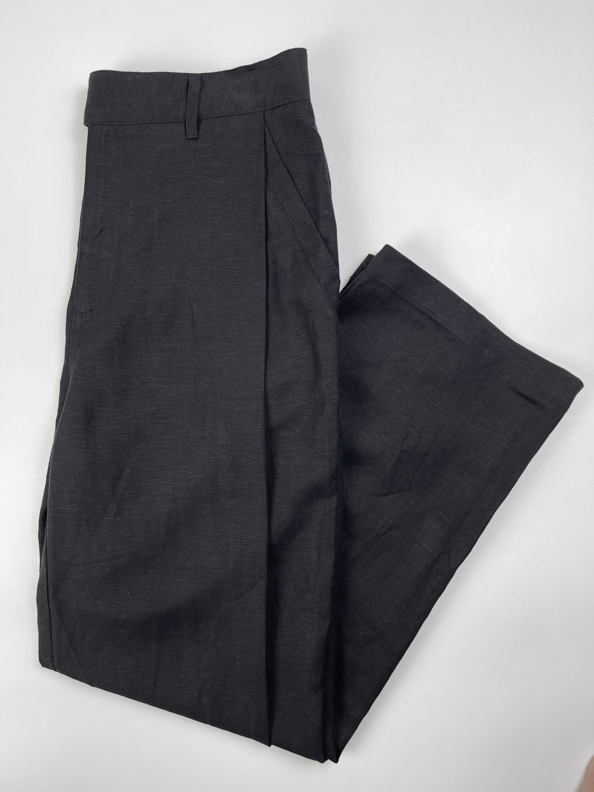 Men's black linen cotton pants with pleated front and elastic waistband by Saigon Concepts - lay flat view