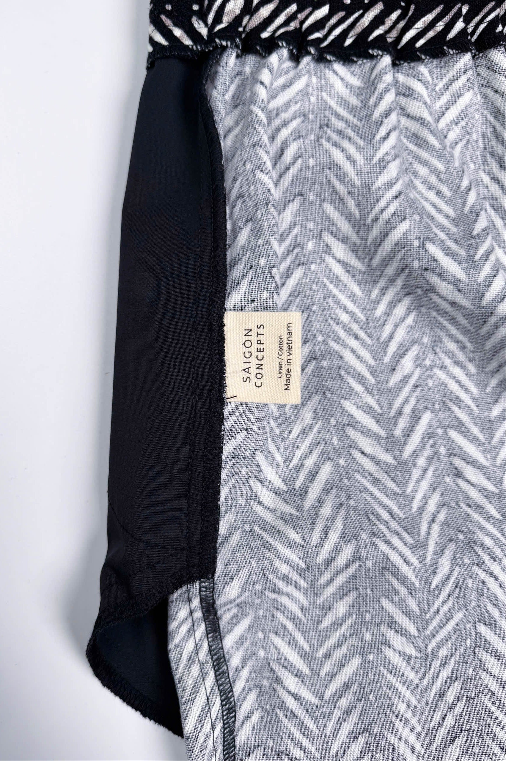 Saigon Concepts Chevron Safari Linen Pants with white chevron painted lines print on black - inside care label view