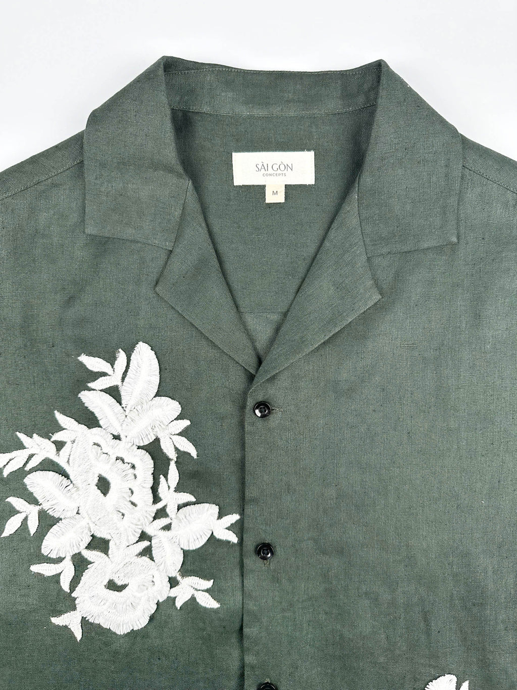 Saigon Concepts Deep Army Green Hawaiian Linen shirt with white floral lace on a light grey background - front collar view
