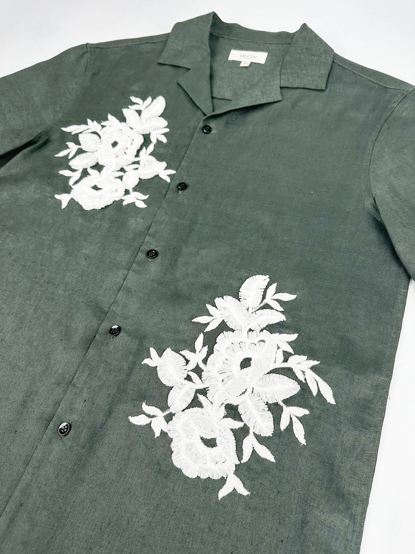 Saigon Concepts Deep Army Green Hawaiian Linen shirt with white floral lace on a light grey background - front side view