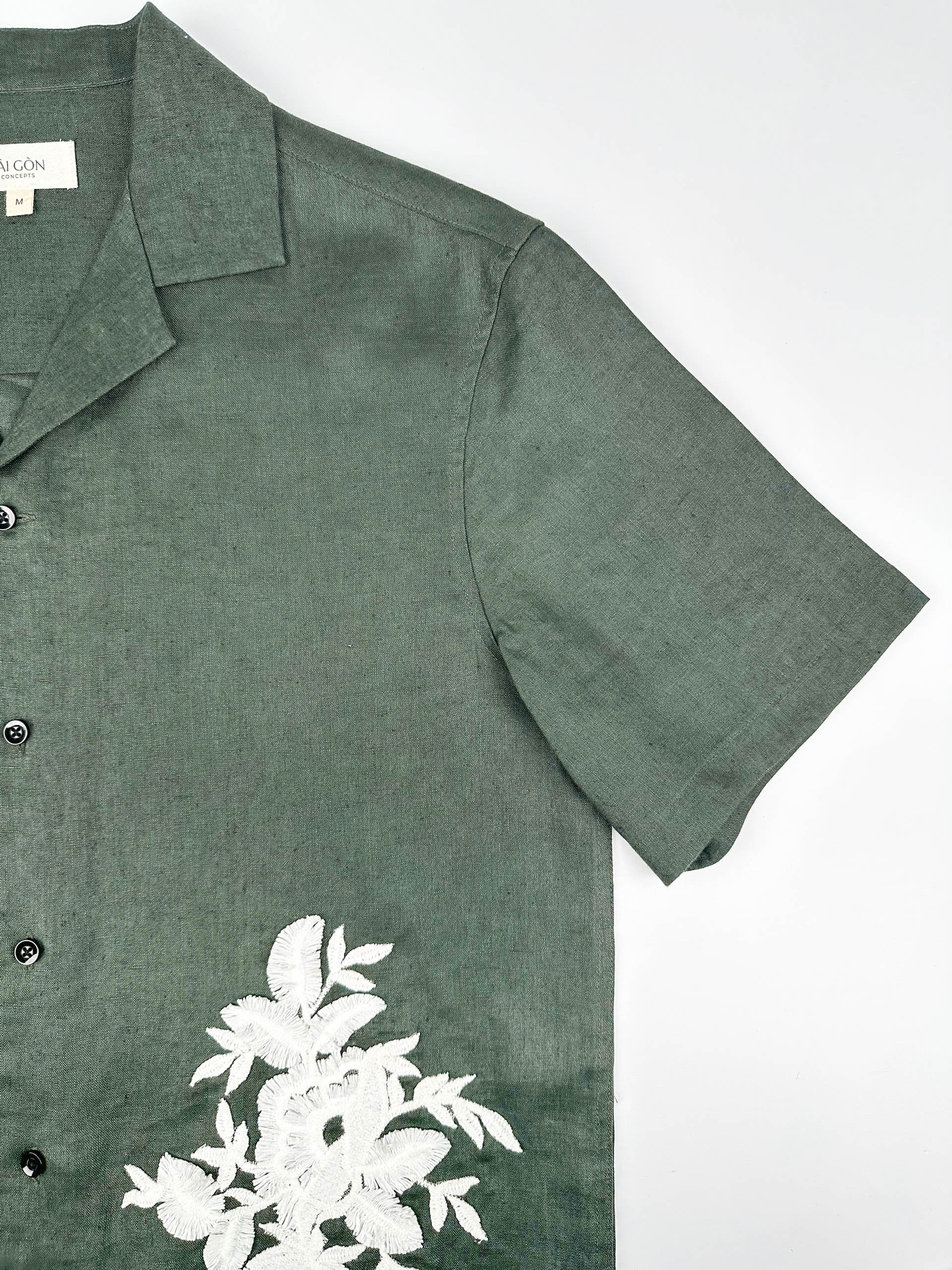 Saigon Concepts Deep Army Green Hawaiian Linen shirt with white floral lace on a light grey background - sleeve detail