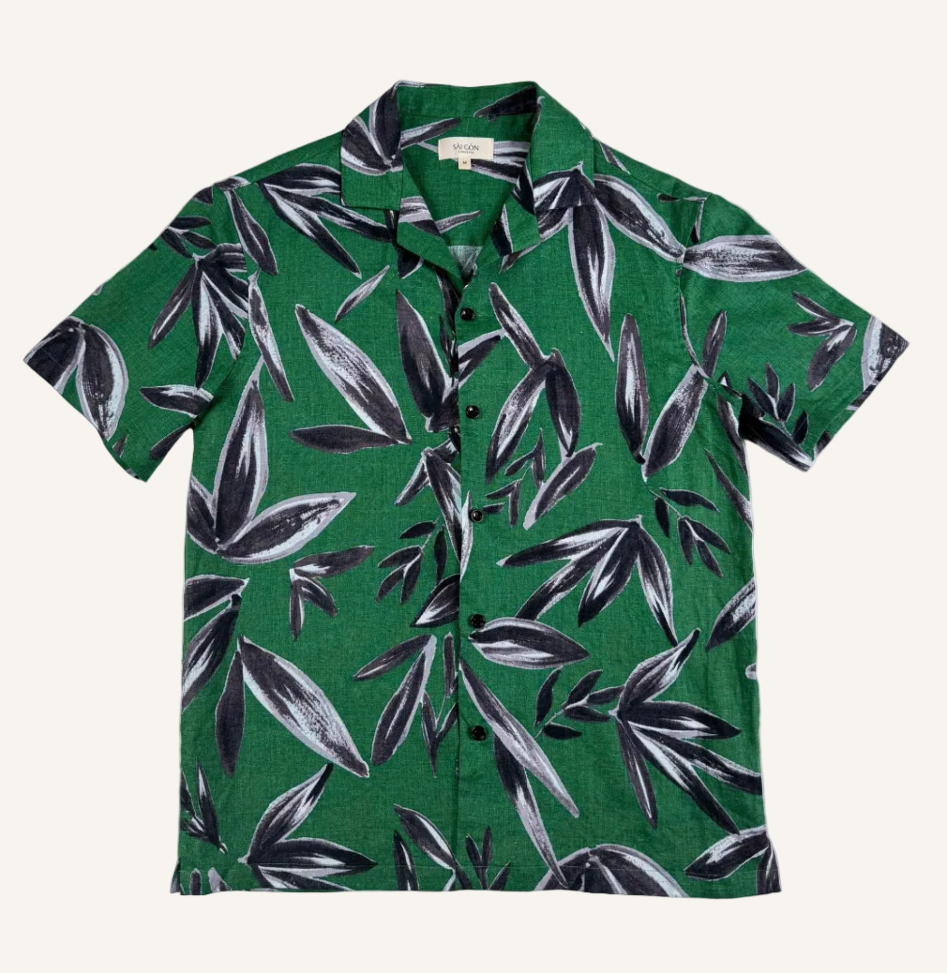 Saigon Concepts Green linen shirt with black leaf pattern on a white background - full front view