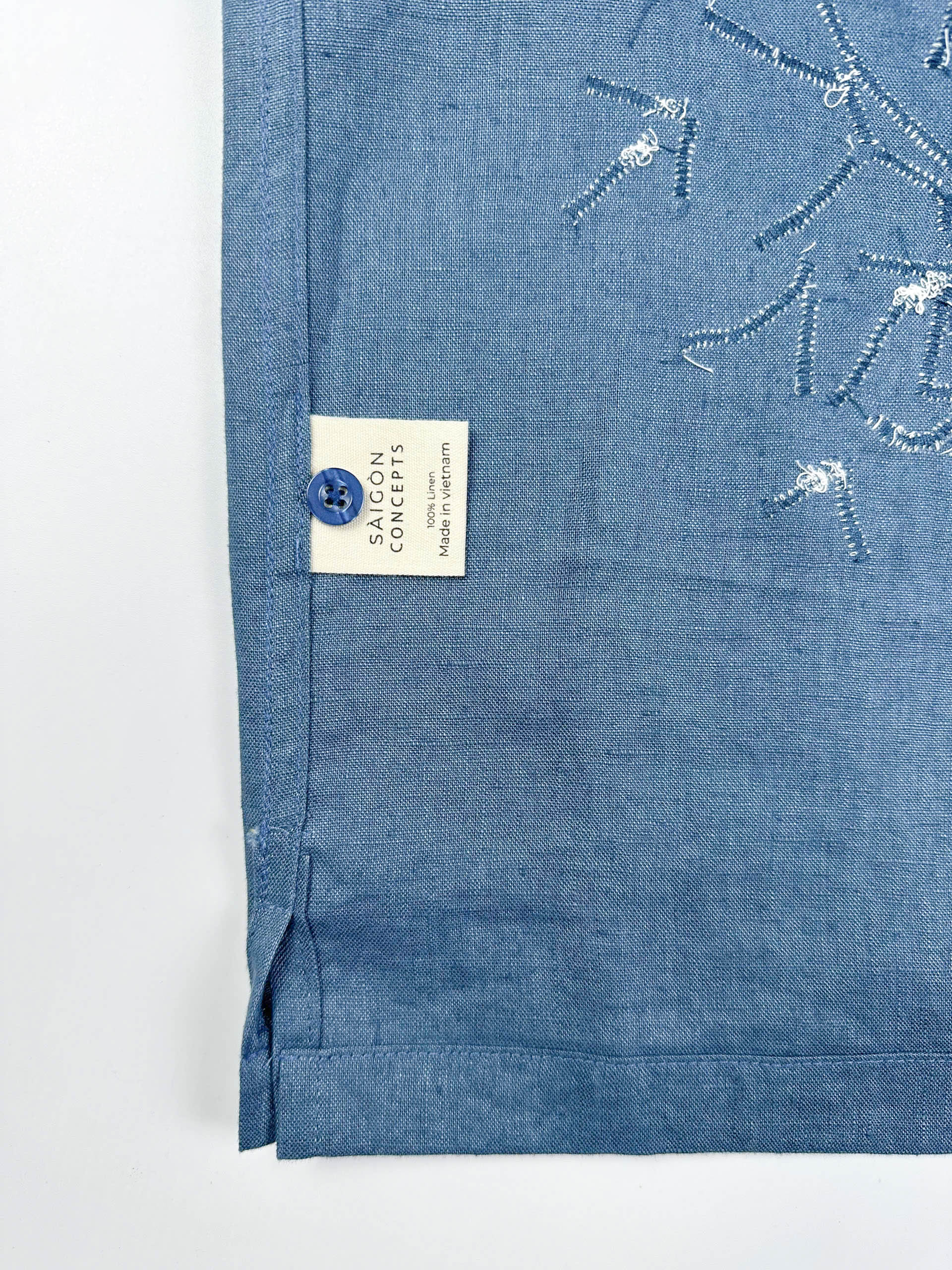 Saigon Concepts Blue steel linen Hawaiian shirt with white lace appliqué detail - care label and spare button detail
