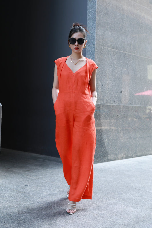 Woman wearing Saigon Concepts Orange Linen Jumpsuit full front view