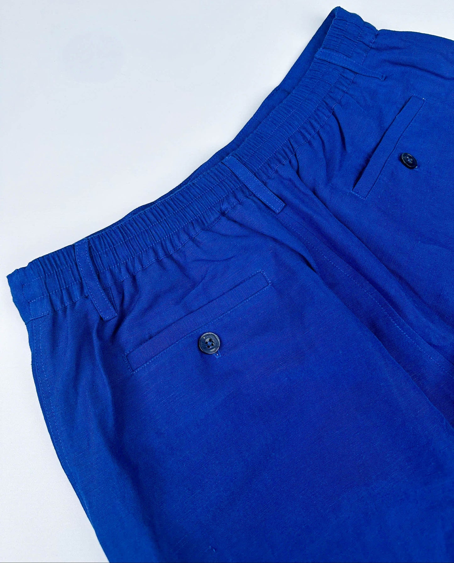 Saigon Concepts Cobalt Blue Riviera Shorts - back elasticated waistband and two back pockets with button closure view 