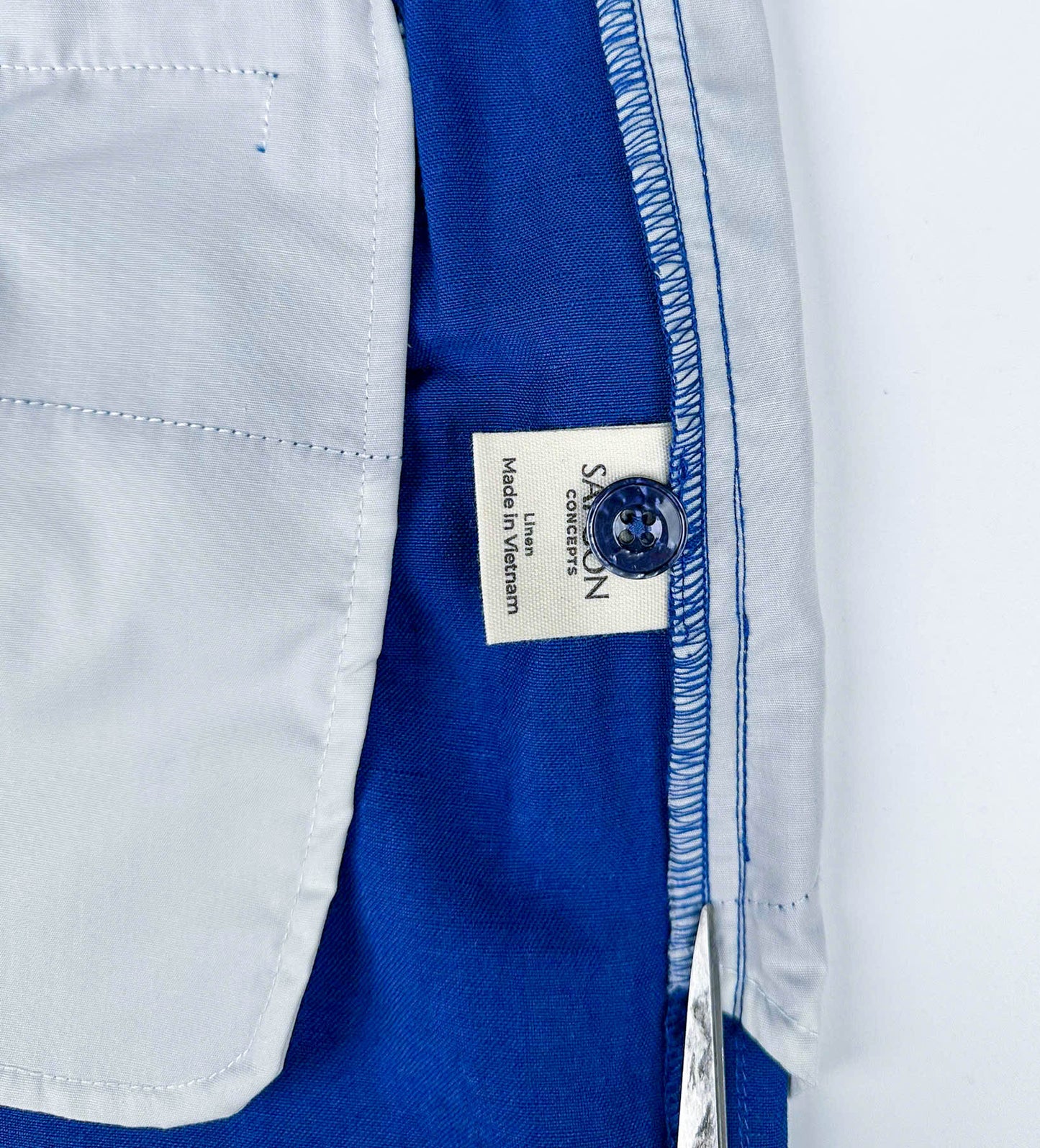 Saigon Concepts Cobalt Blue Riviera Shorts - inside care label with spare button detail view