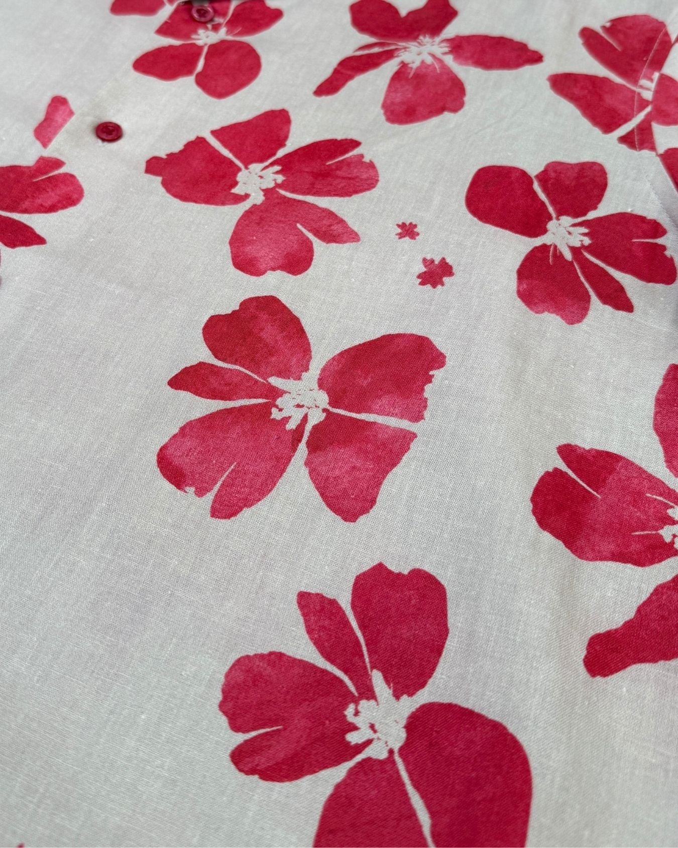 Ruby Red floral pattern on a beige colour print - fabric detail view
