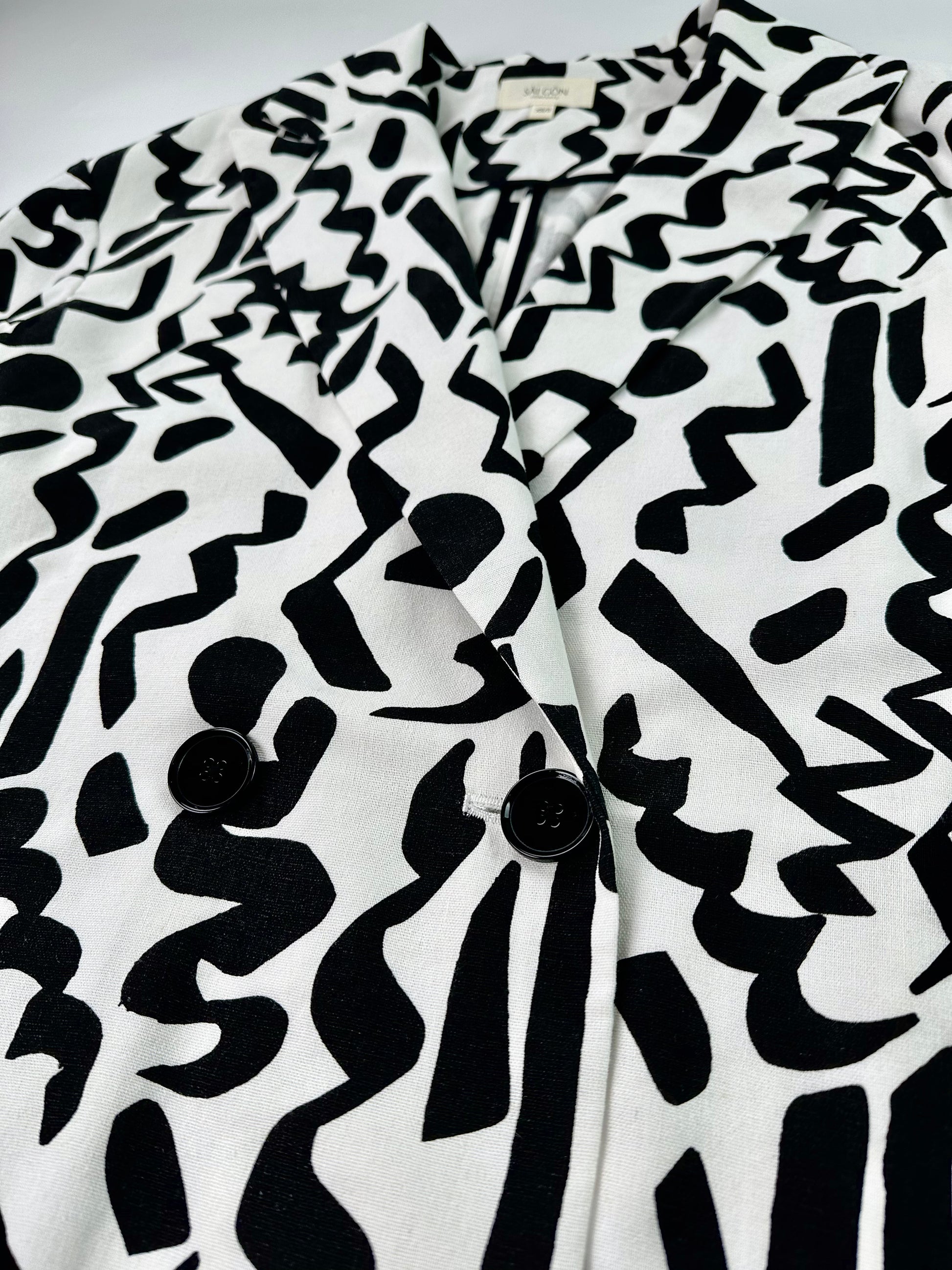 Saigon Concepts Black and white Urban Canvas patterned jacket on a light grey background - front button detail view