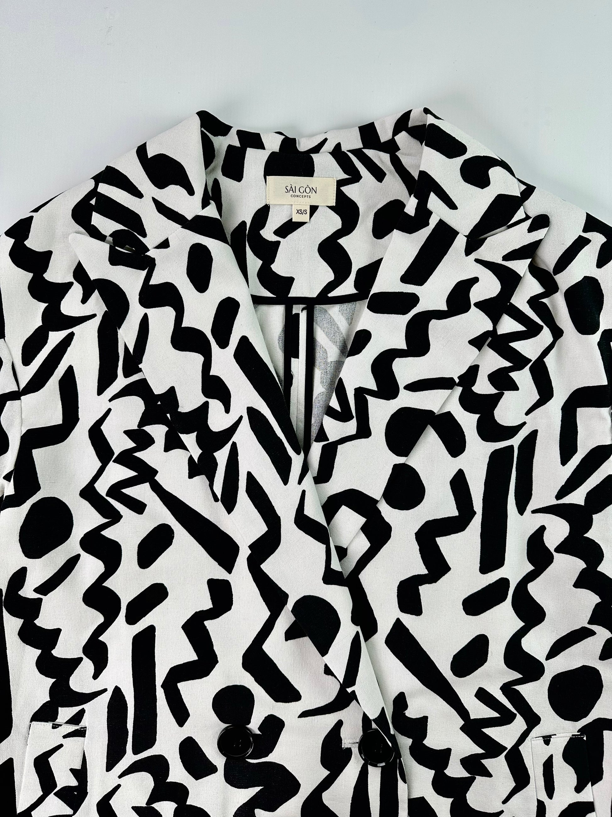 Saigon Concepts Black and white Urban Canvas patterned jacket on a light grey background - front collar detail